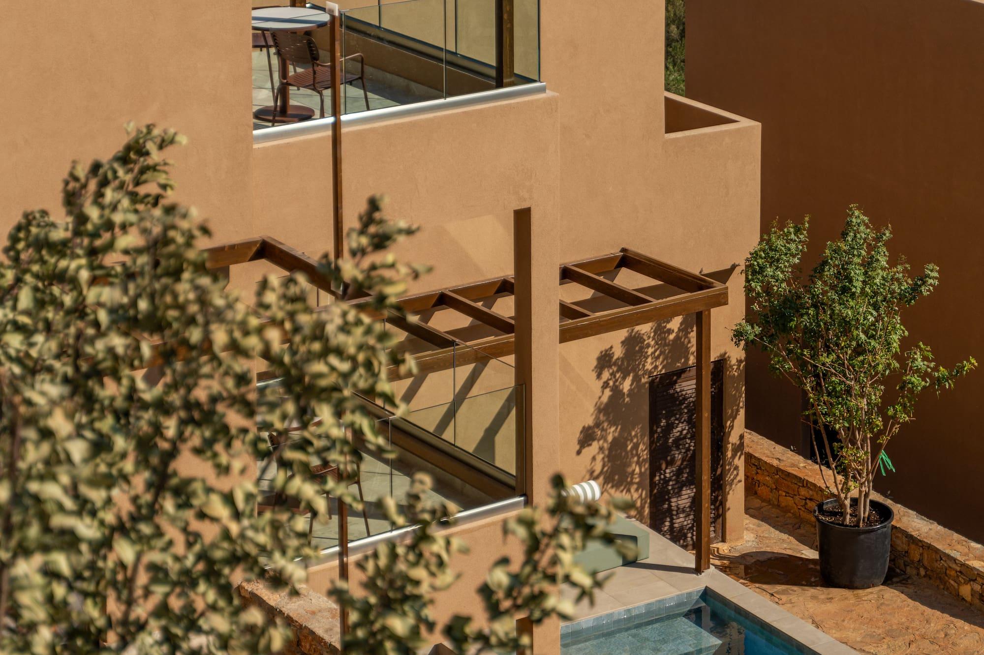 a building with a pool and a tree