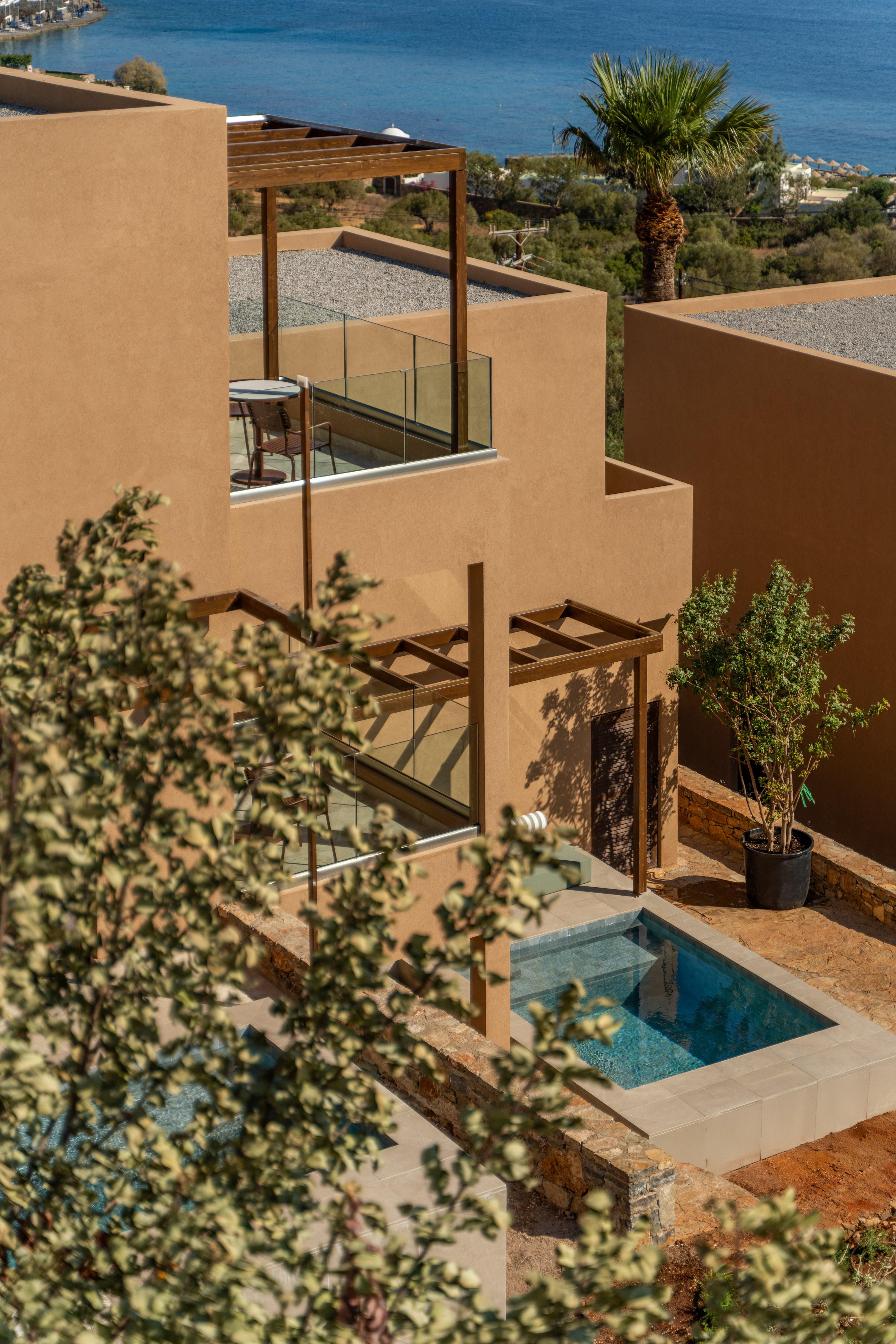 Modern resort villa with private pool, balcony, and sea view.