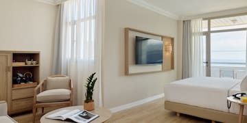 a room with a bed and a television on the wall