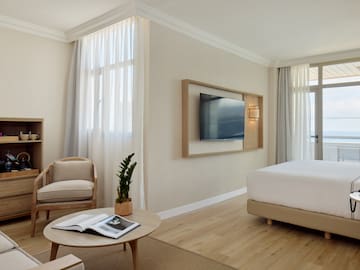 a room with a bed and a television on the wall