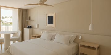 a bedroom with a ceiling fan and a bed