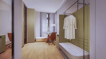 a room with a white robe on a rack