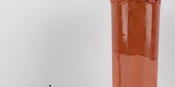 a glass with a drink and a plate of food