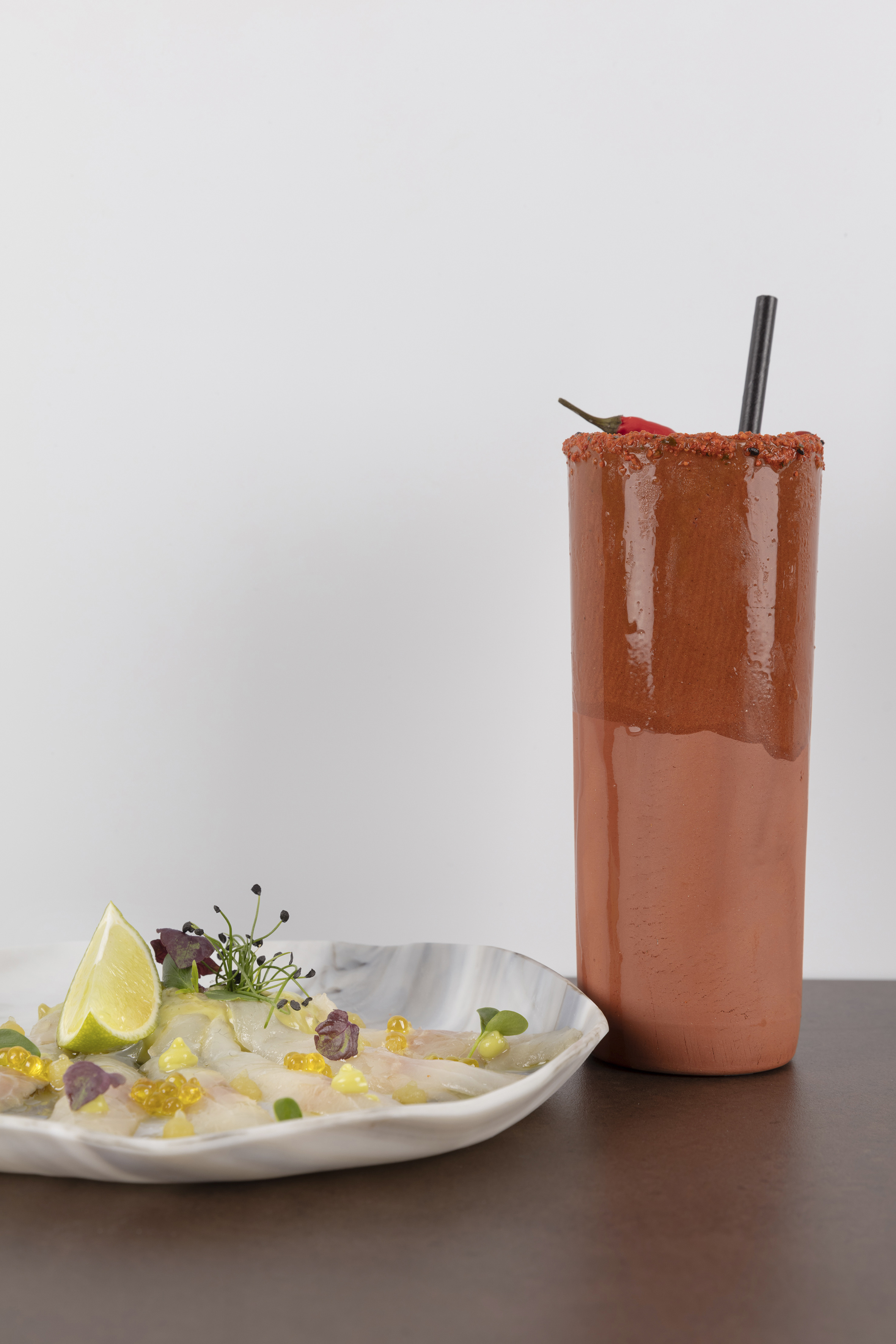 a glass with a drink and a plate of food