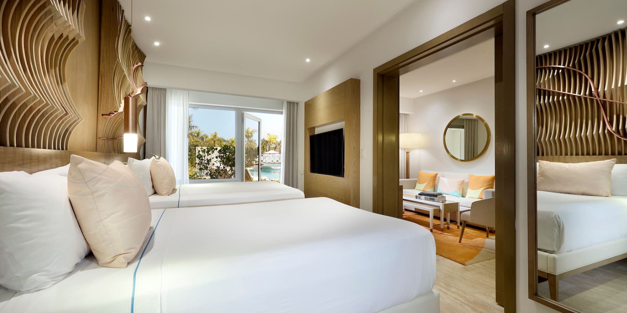 a bedroom with two beds and a television