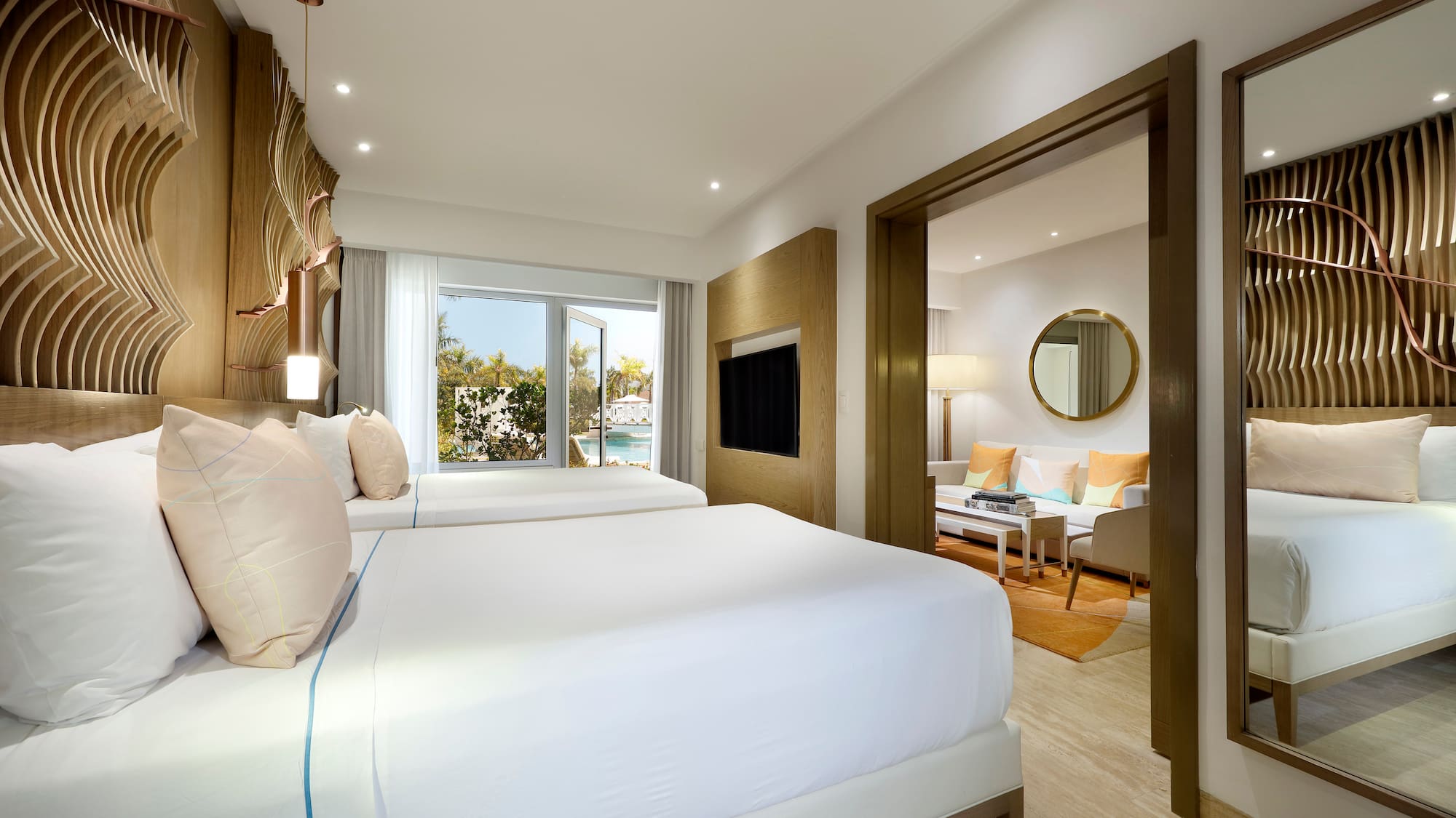 a bedroom with two beds and a television