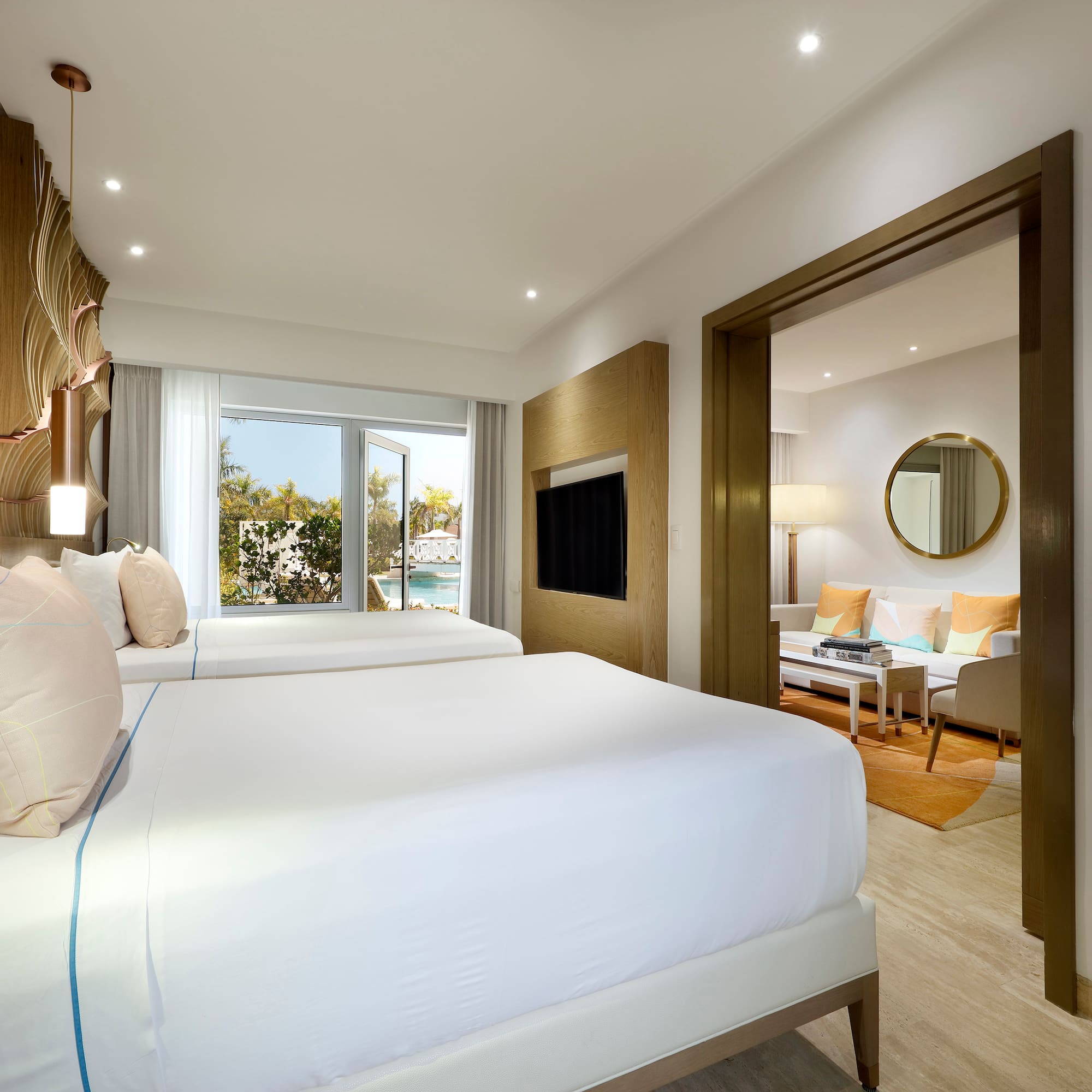 a bedroom with two beds and a television