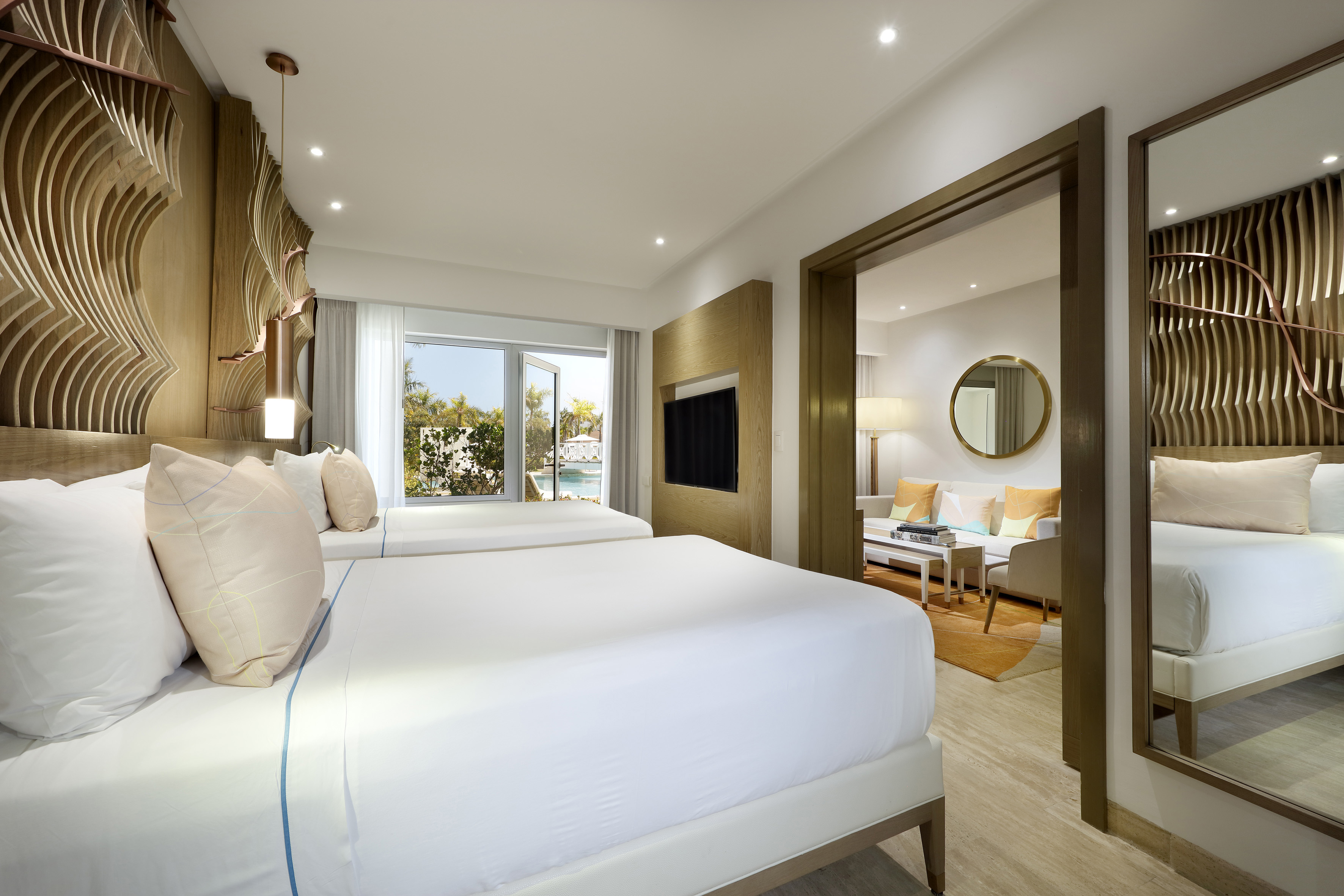 a bedroom with two beds and a television