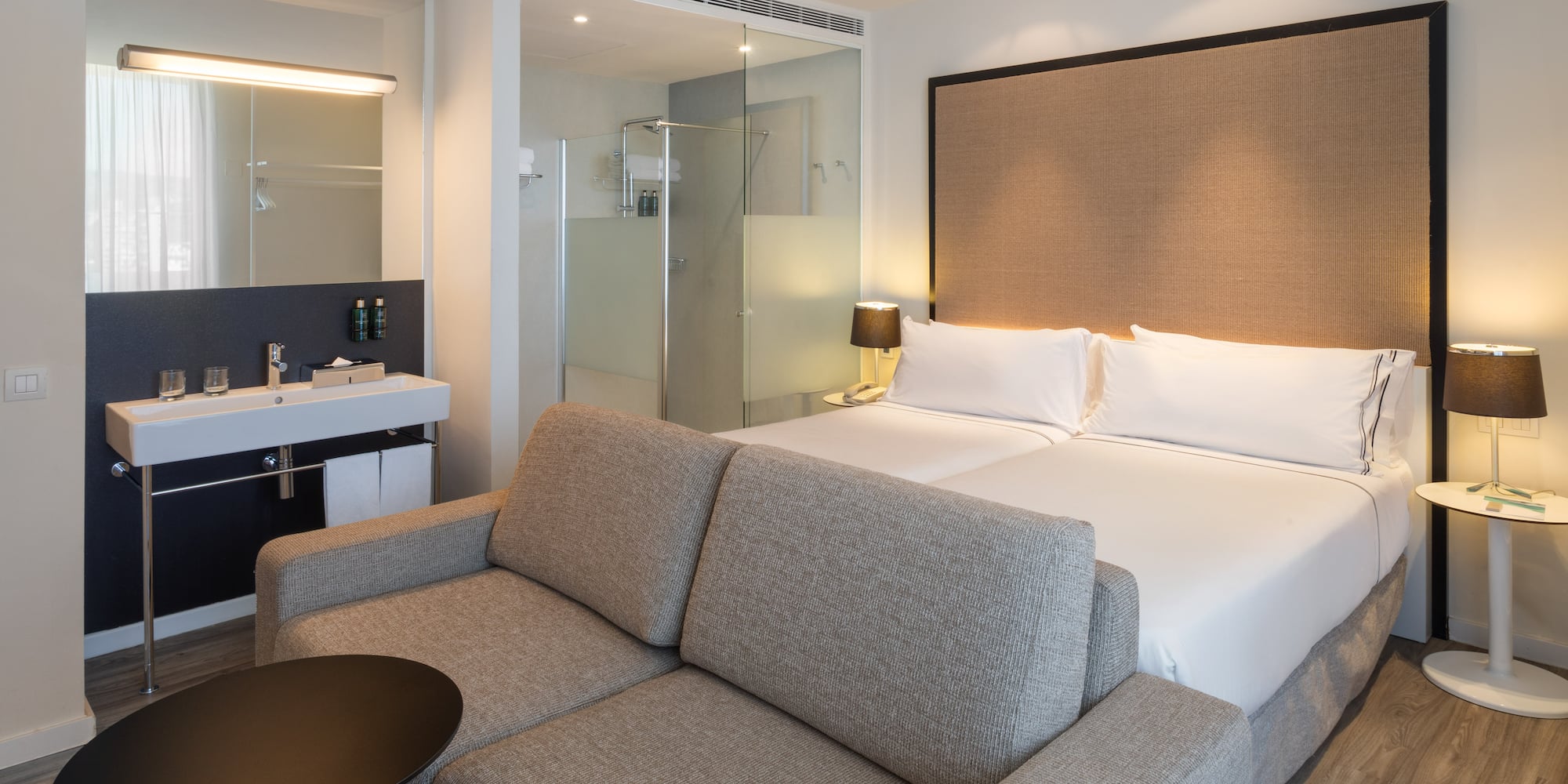 a hotel room with a bed and a shower