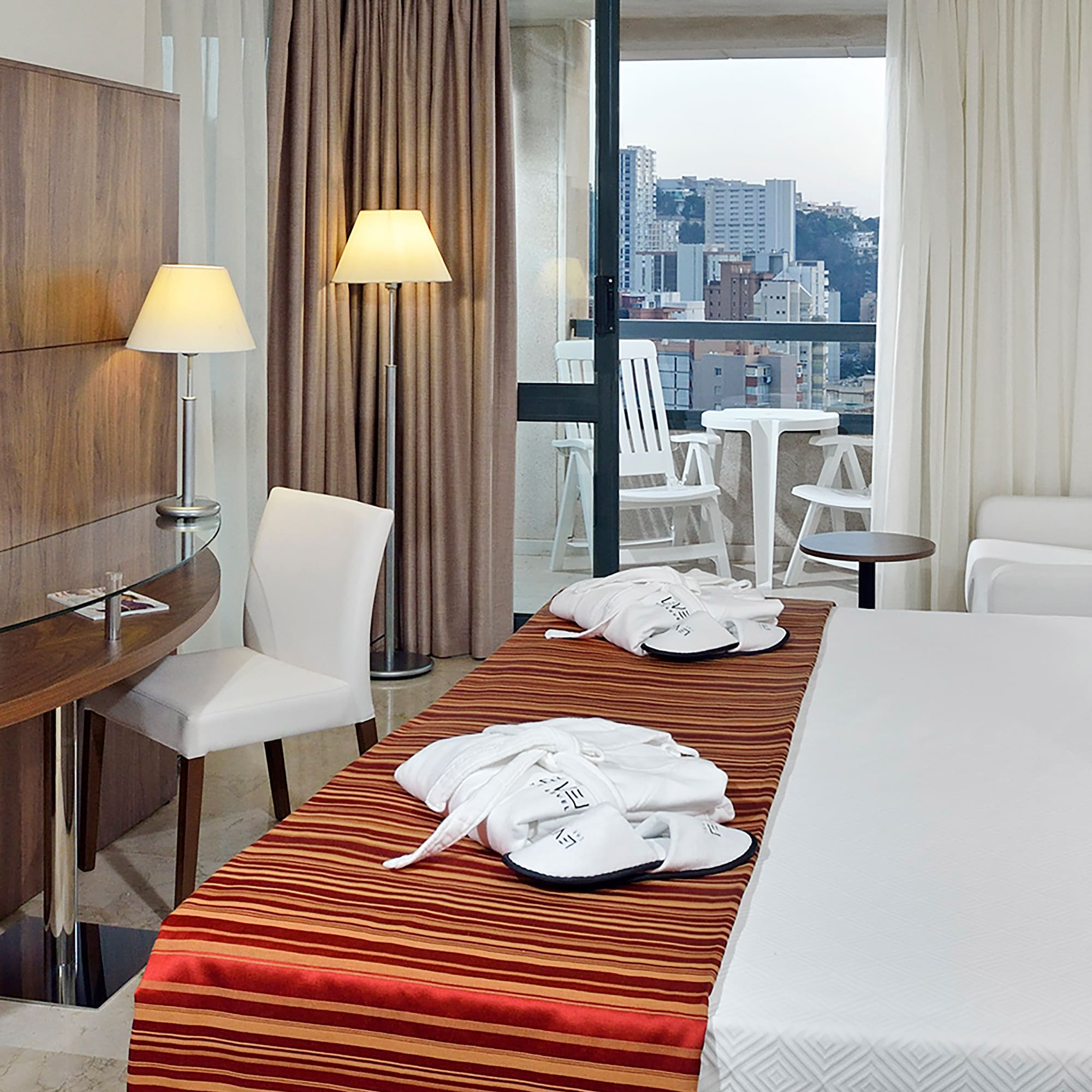 a hotel room with a bed and chairs