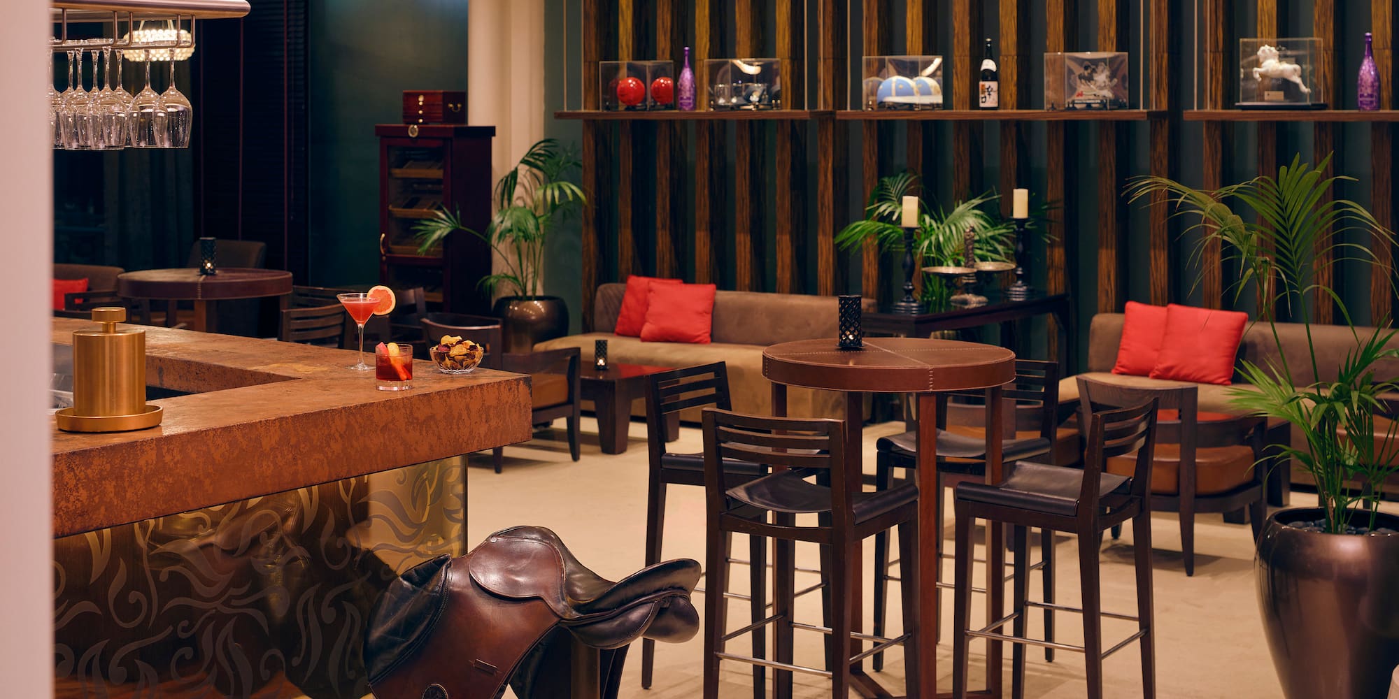 a room with a bar and chairs