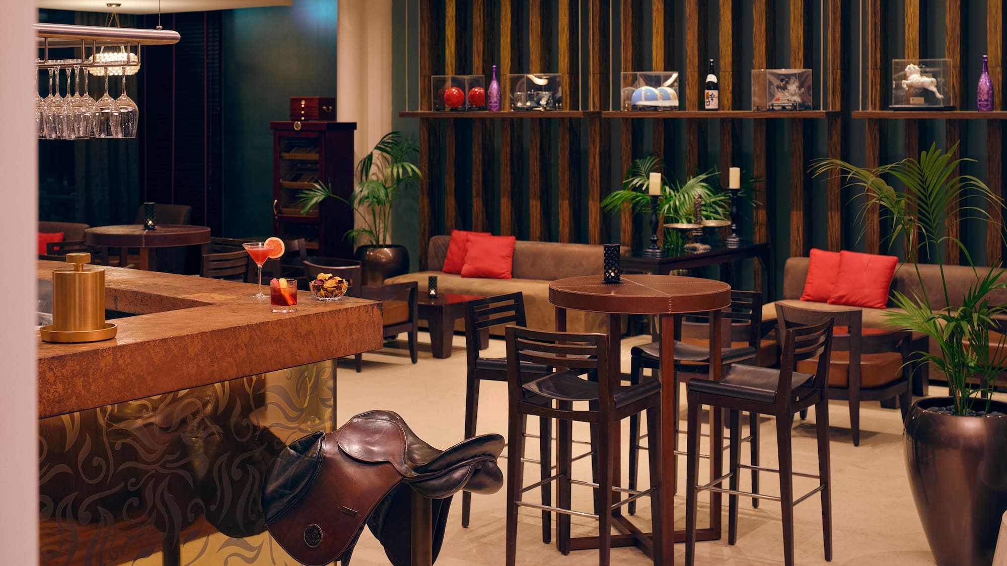 a room with a bar and chairs