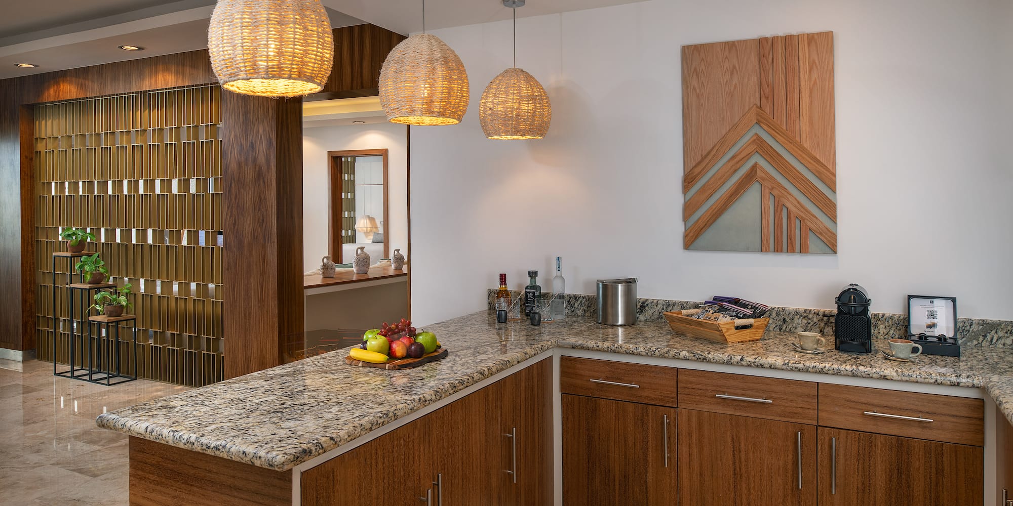 a kitchen with a marble countertop and lights