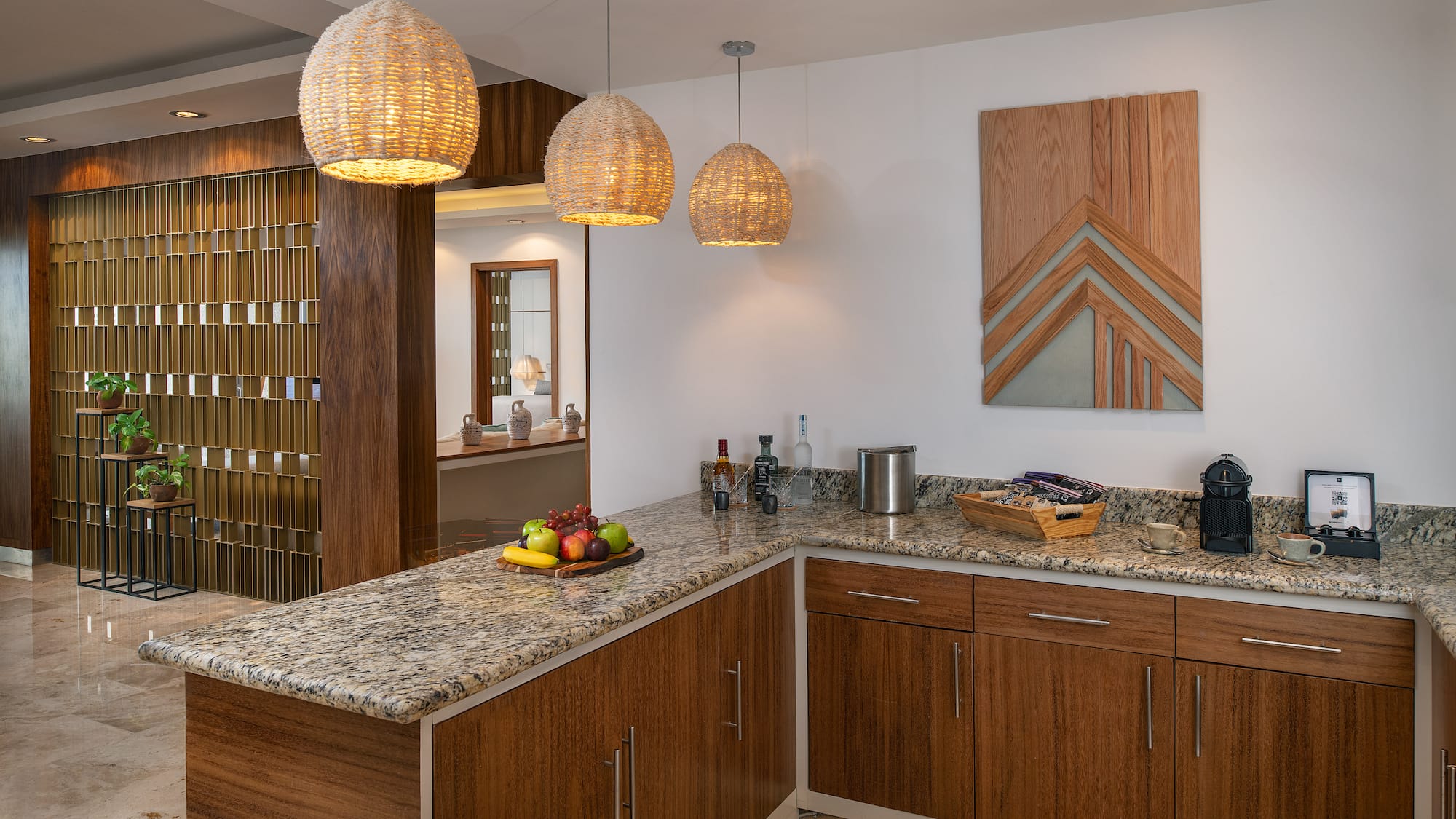 a kitchen with a marble countertop and lights