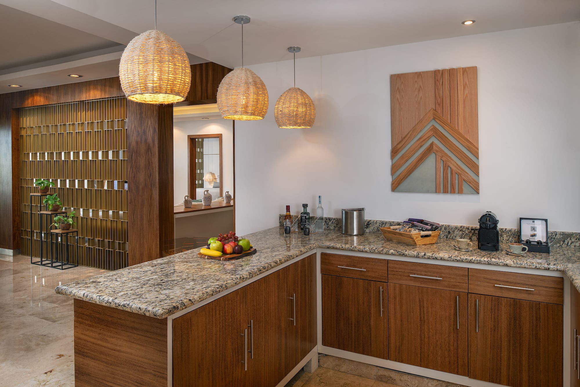 a kitchen with a marble countertop and lights