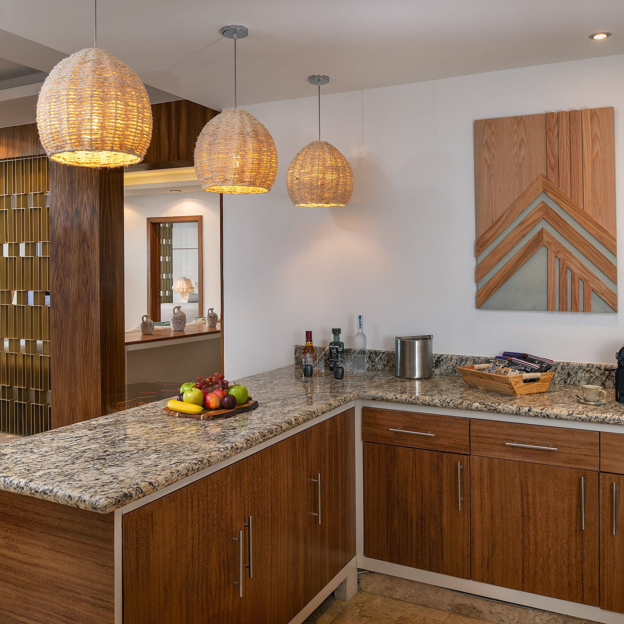 a kitchen with a marble countertop and lights