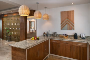 a kitchen with a marble countertop and lights