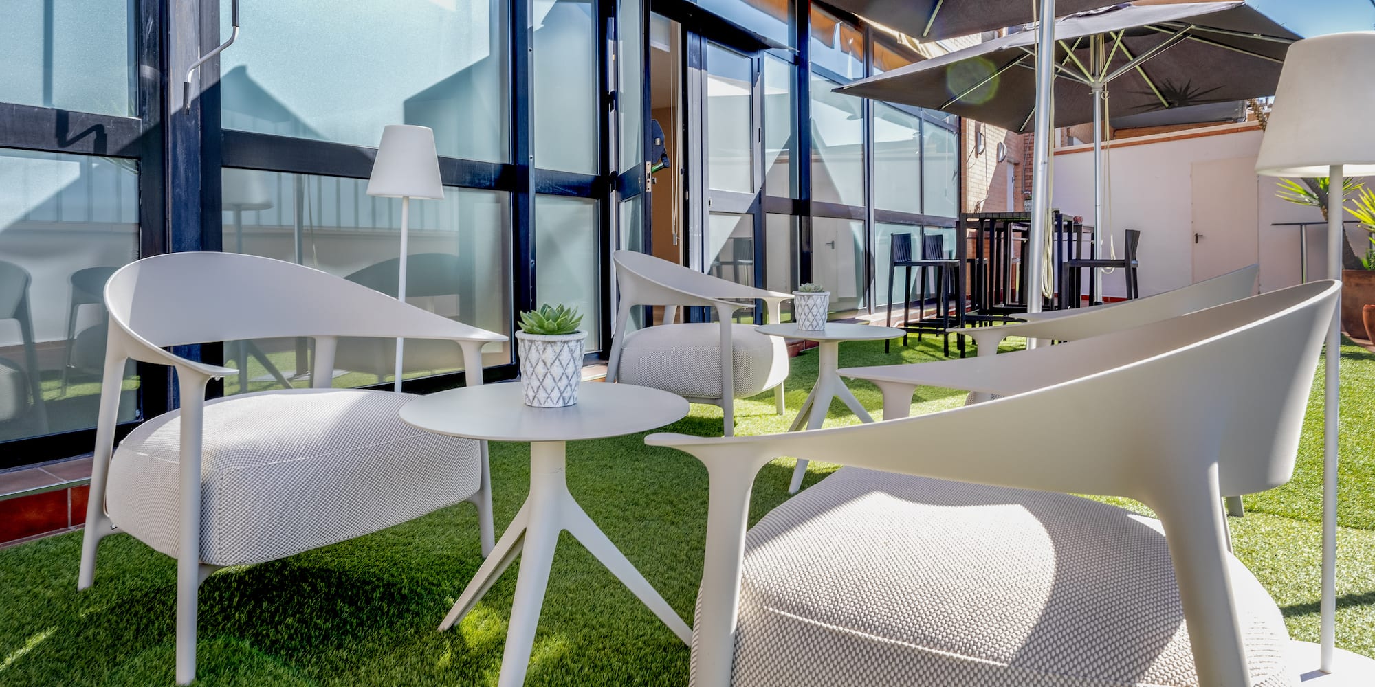 a patio area with chairs and umbrellas