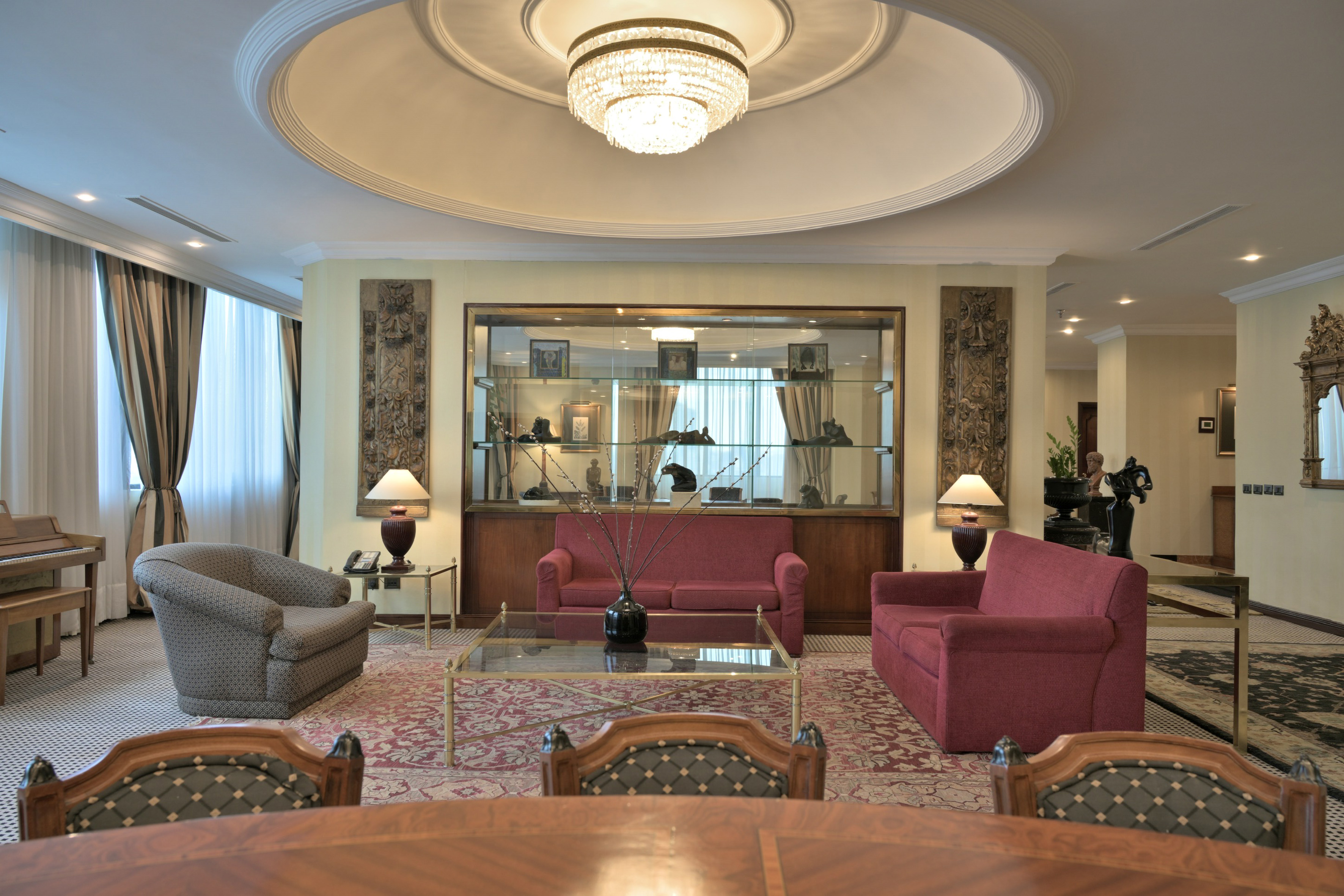 a room with a chandelier and couches