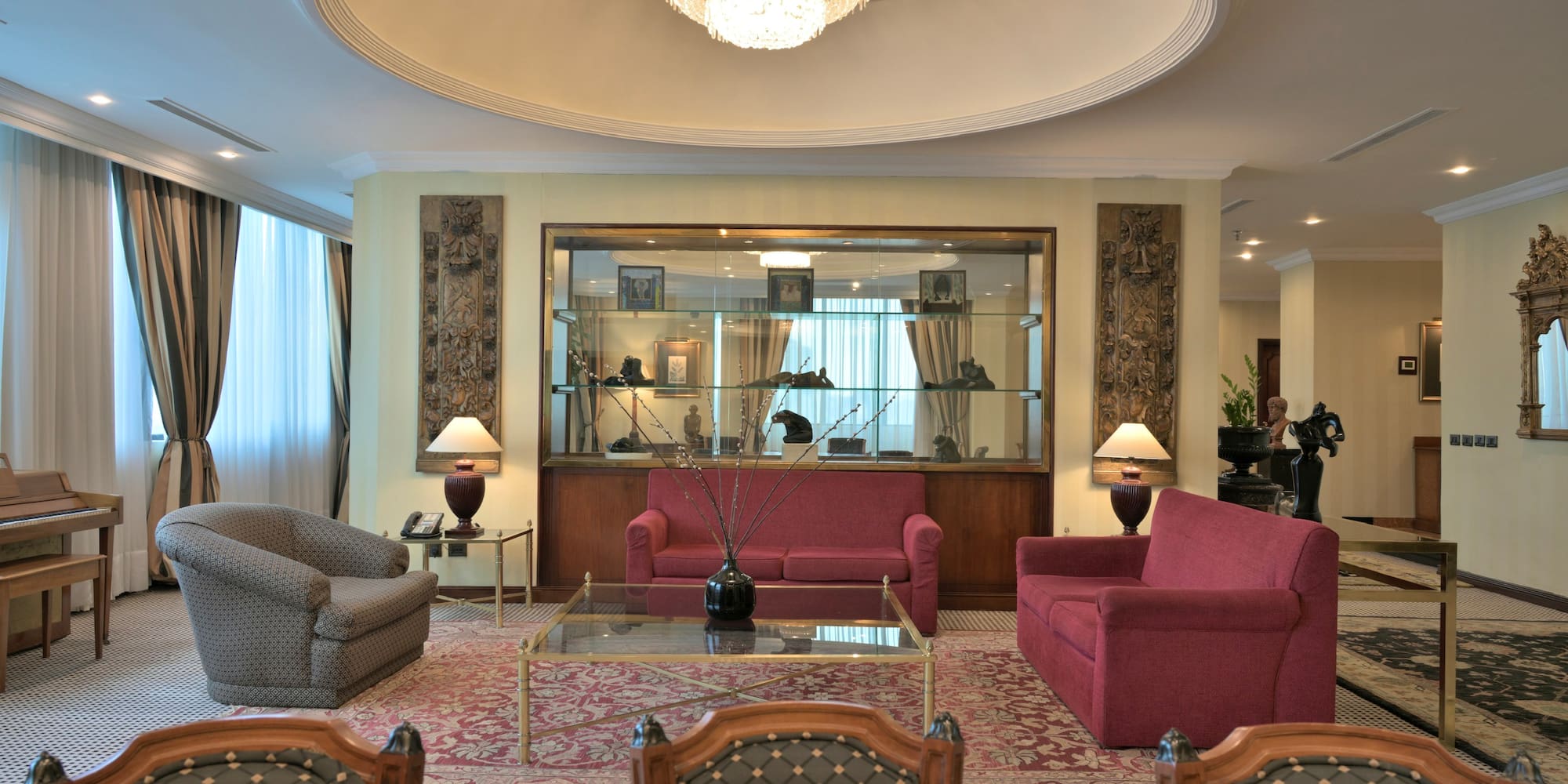 a room with a chandelier and couches