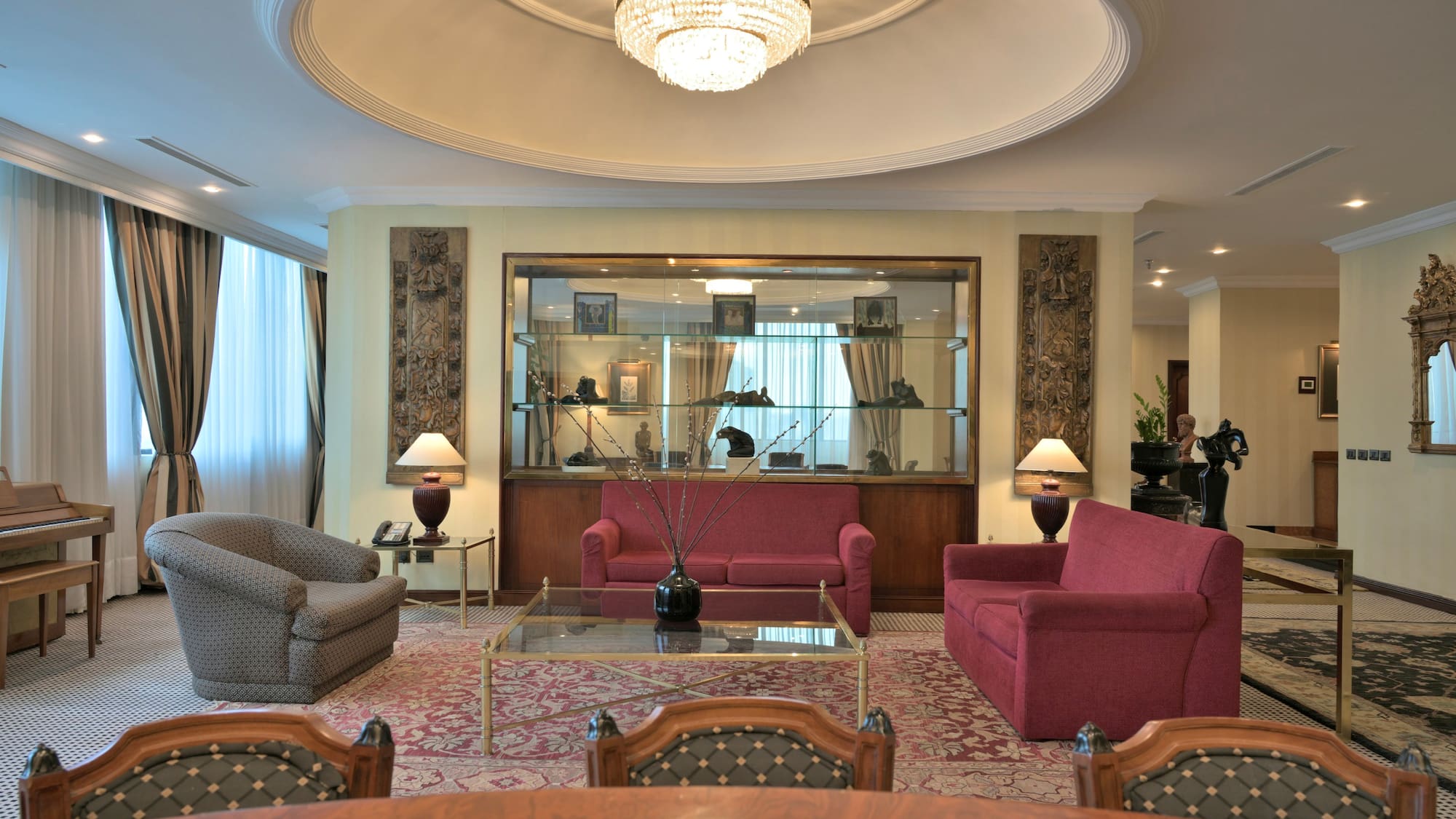 a room with a chandelier and couches