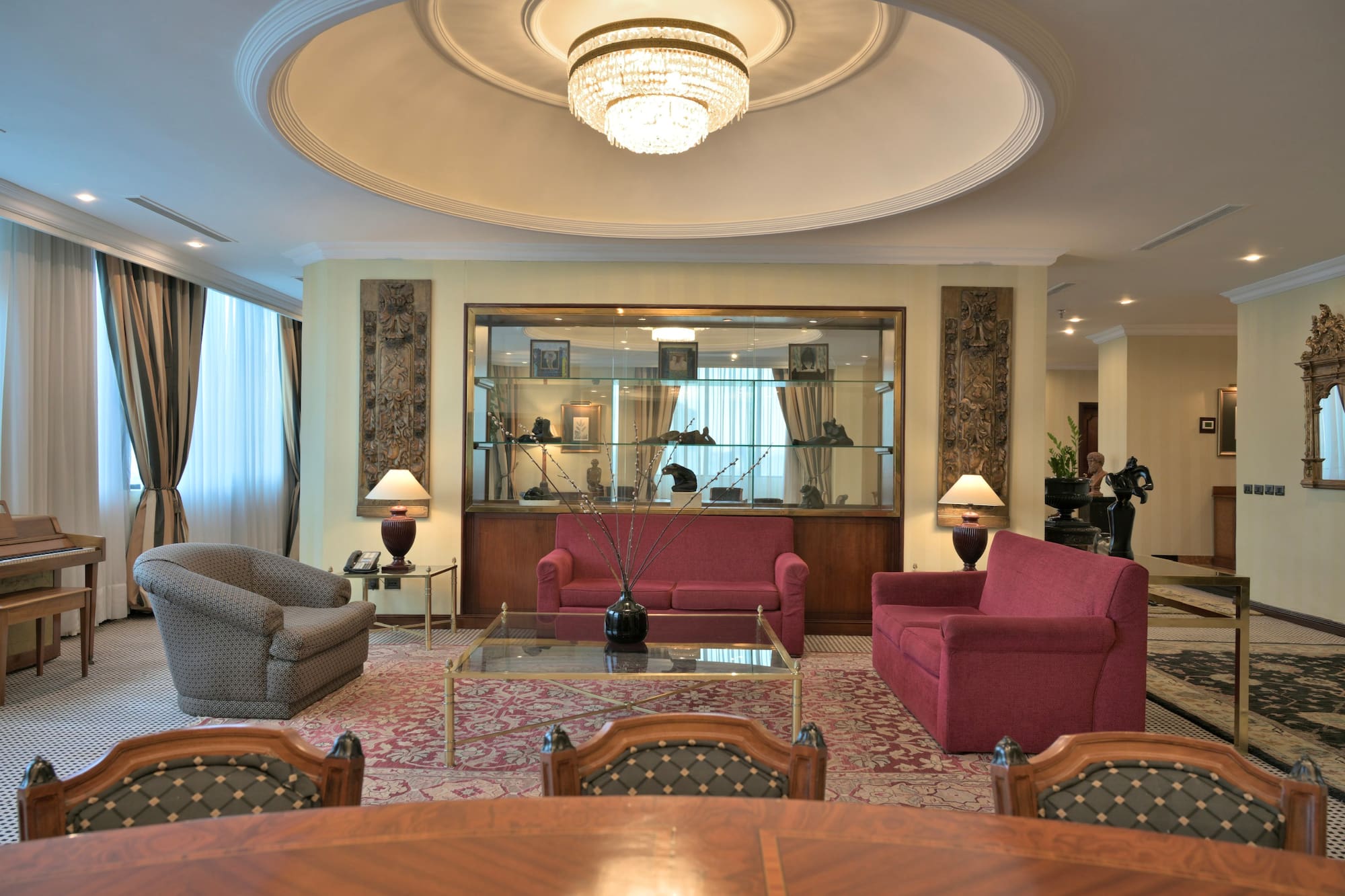 a room with a chandelier and couches