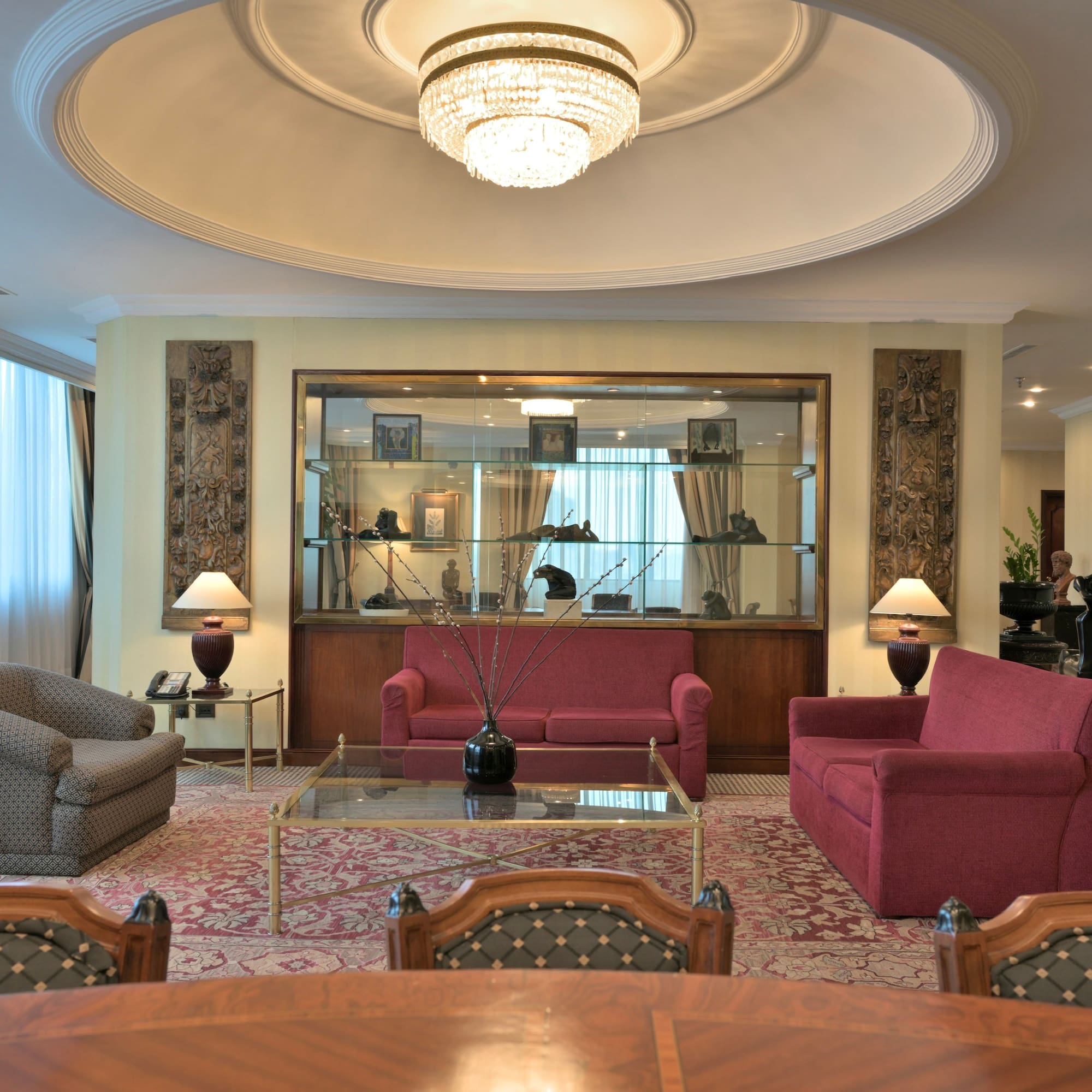 a room with a chandelier and couches