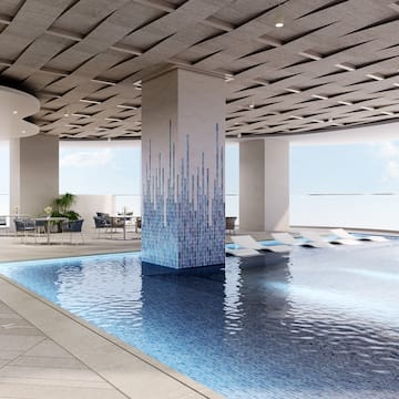 a pool with chairs and a large ceiling