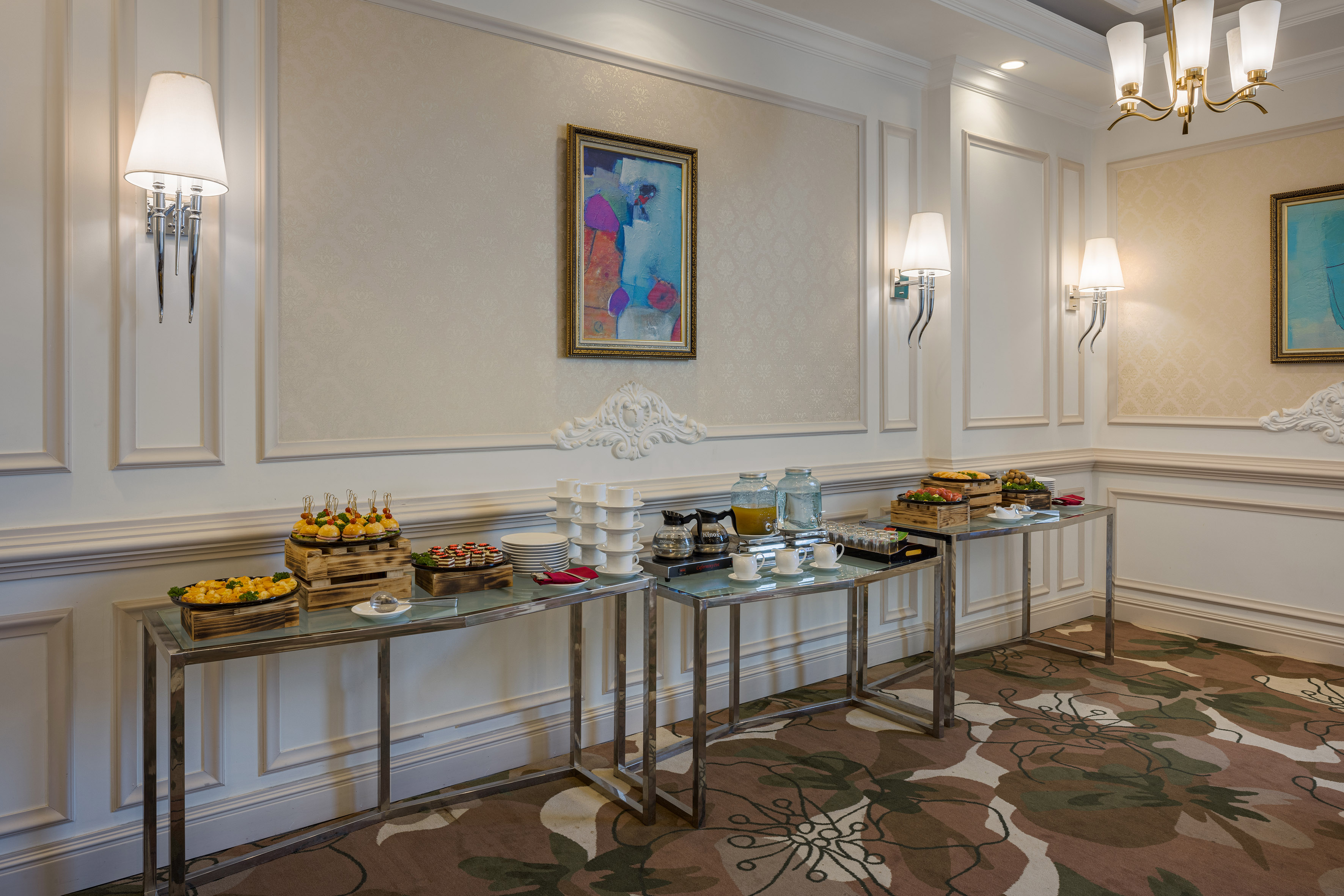 Elegant room with catering buffet, appetizers, coffee, and juice.