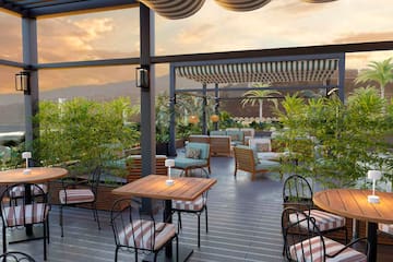 a patio with tables and chairs