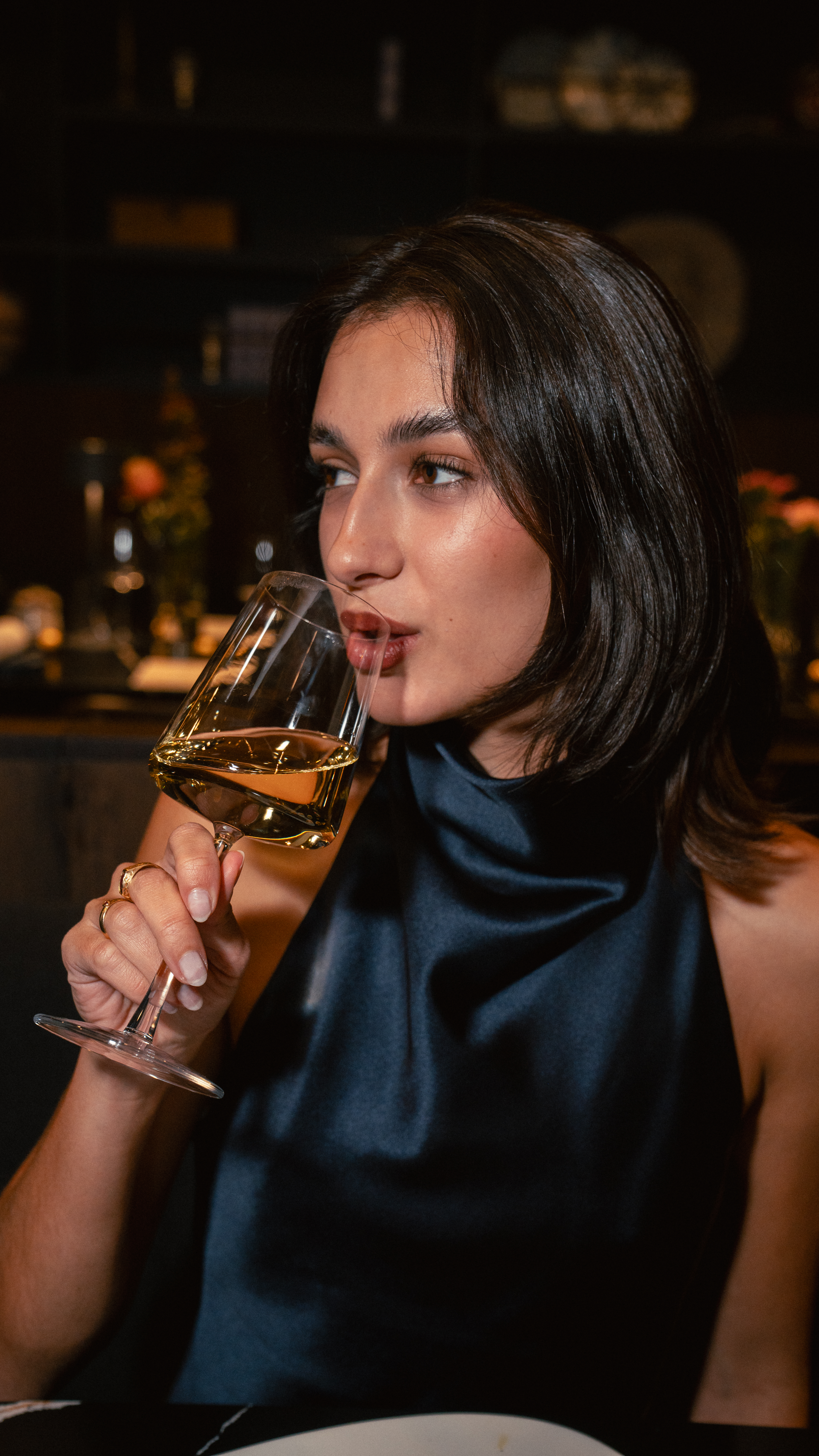 a woman drinking from a glass