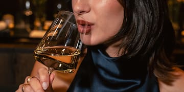 a woman drinking from a glass