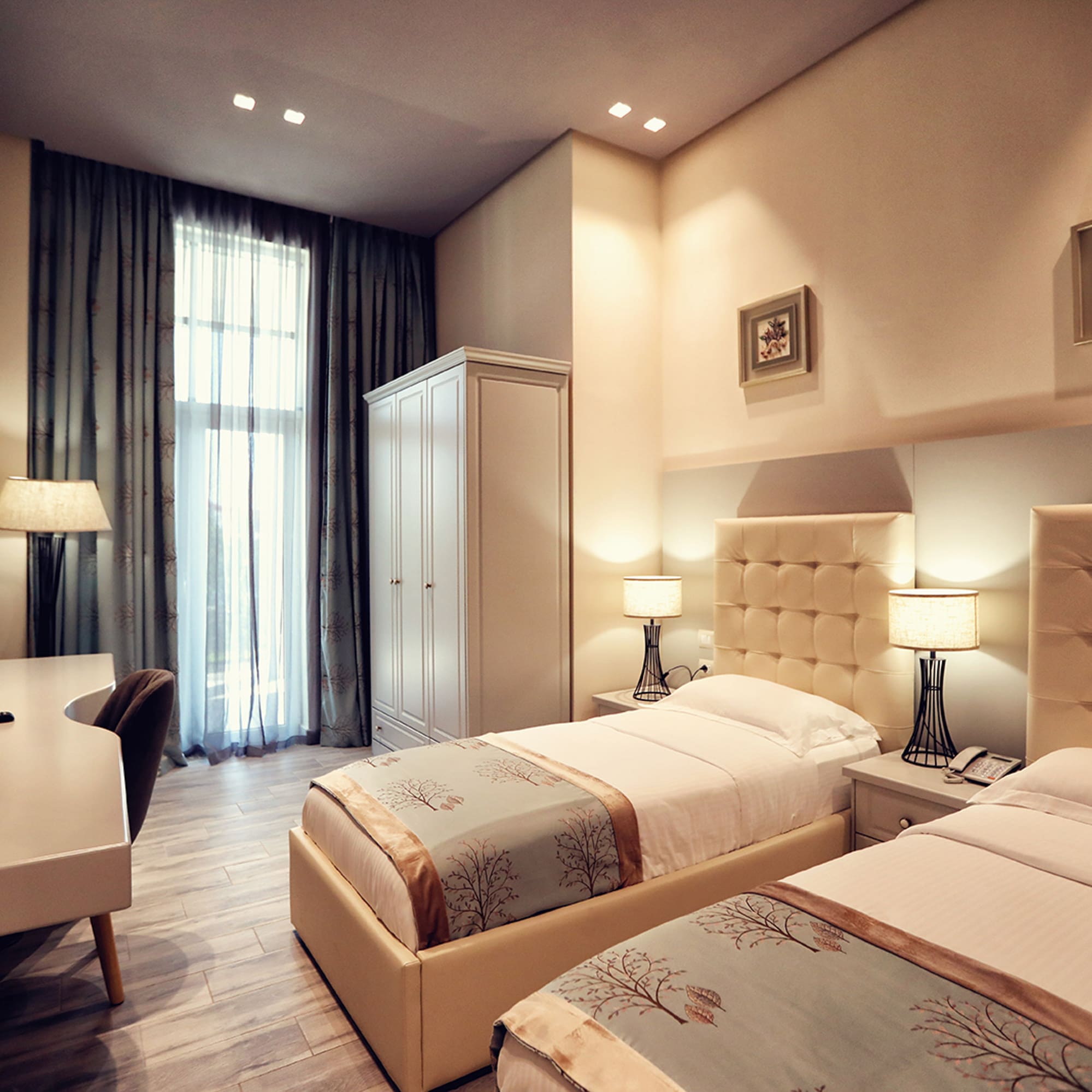 a room with two beds and a desk