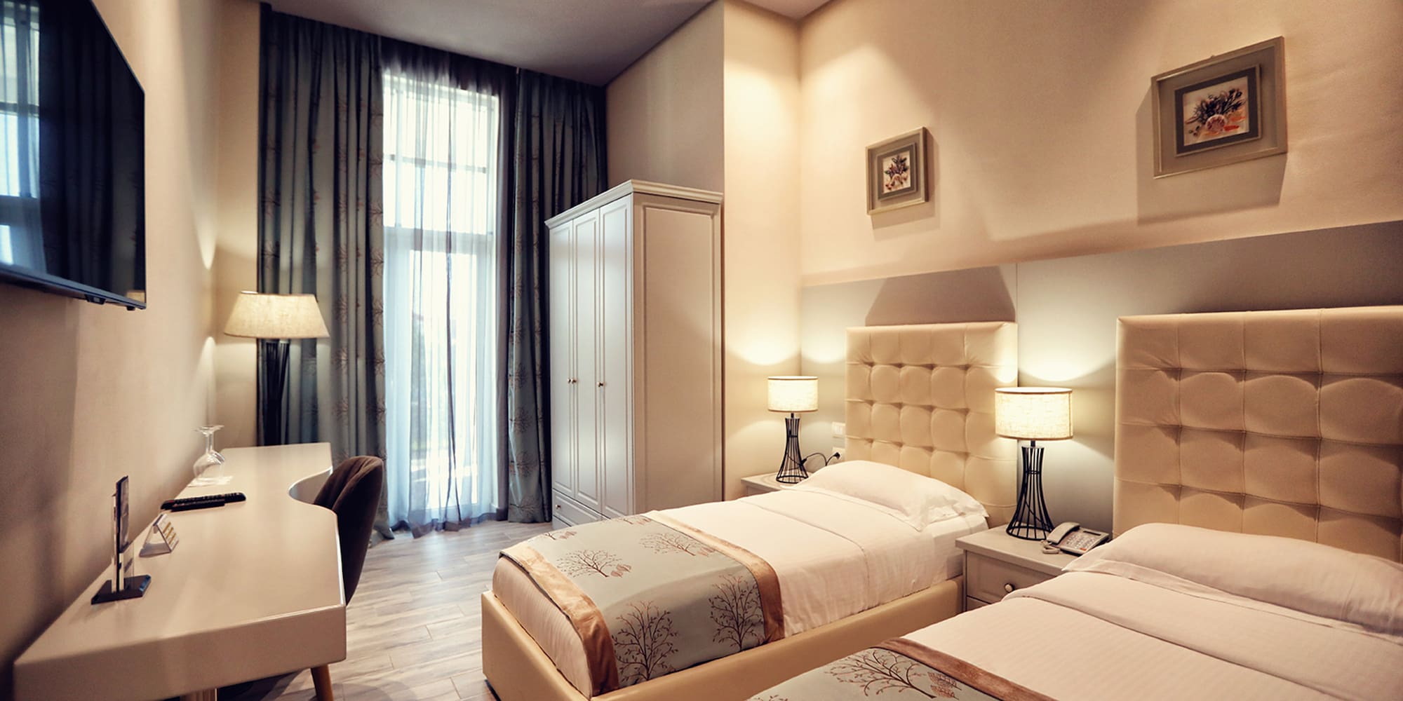 a room with two beds and a desk