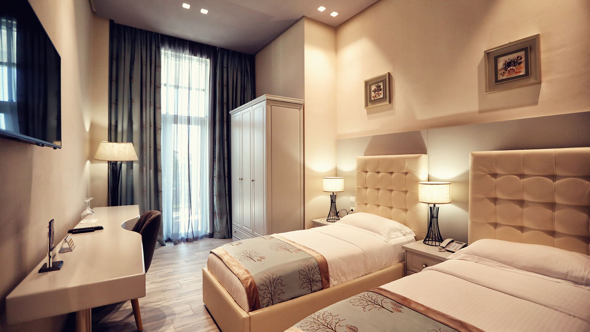 a room with two beds and a desk