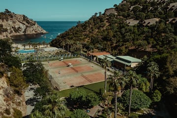 a tennis court near a body of water