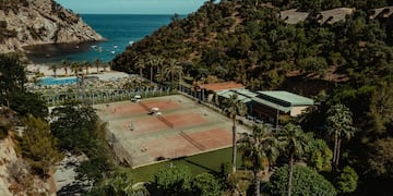 a tennis court near a body of water