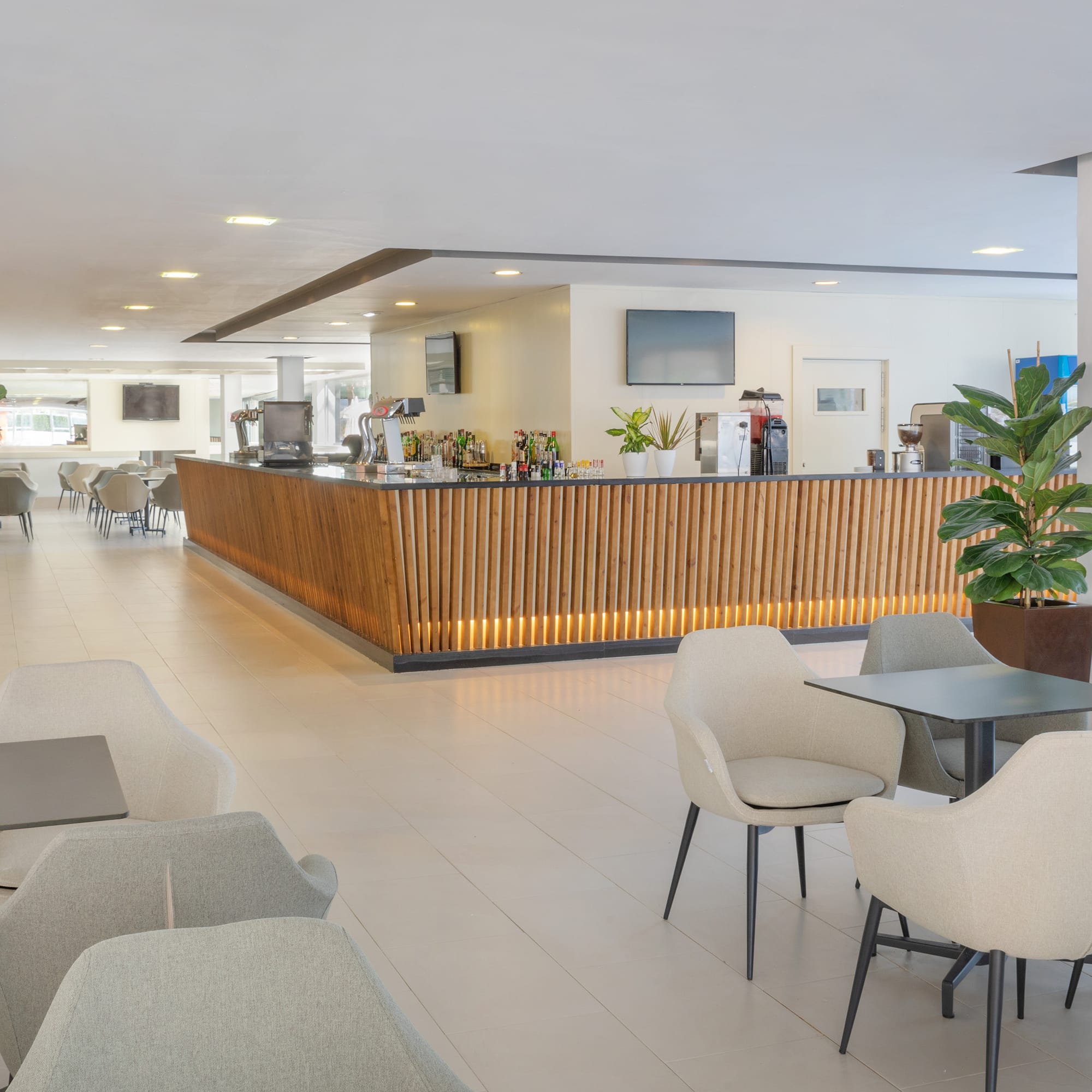 a room with a counter and chairs