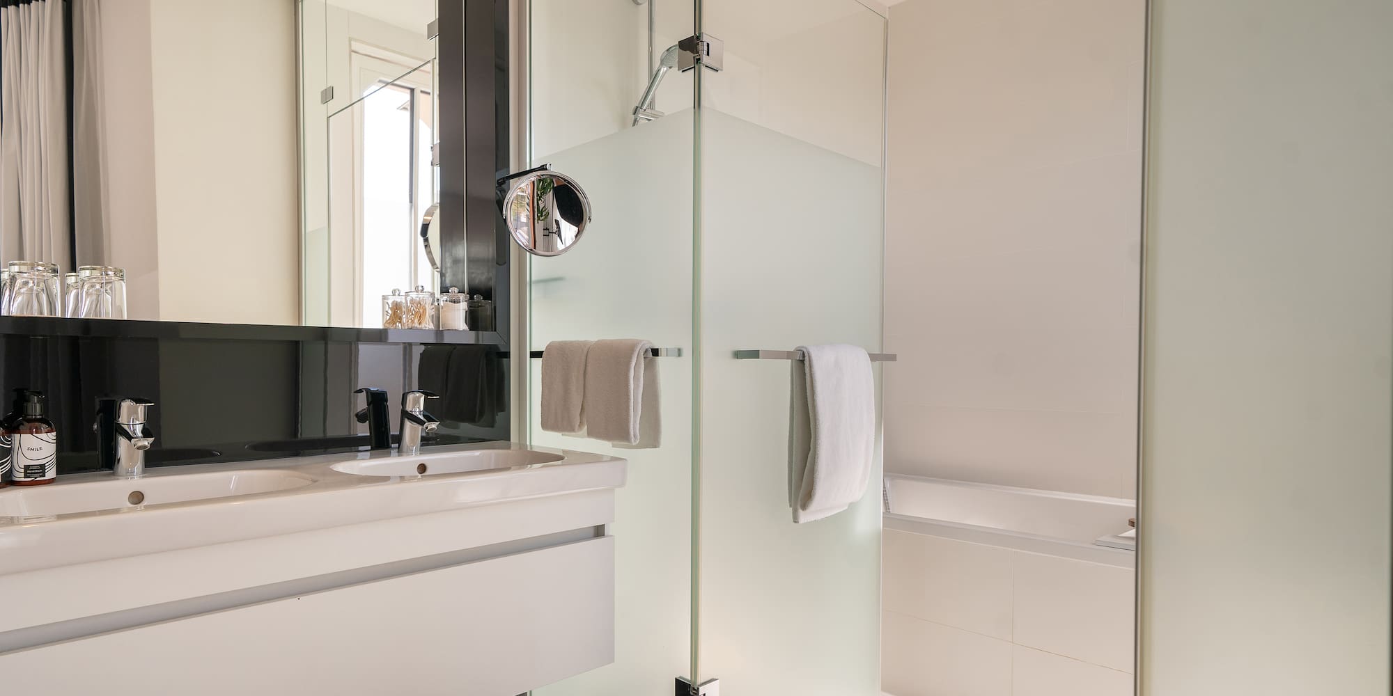 a bathroom with a glass shower and sink