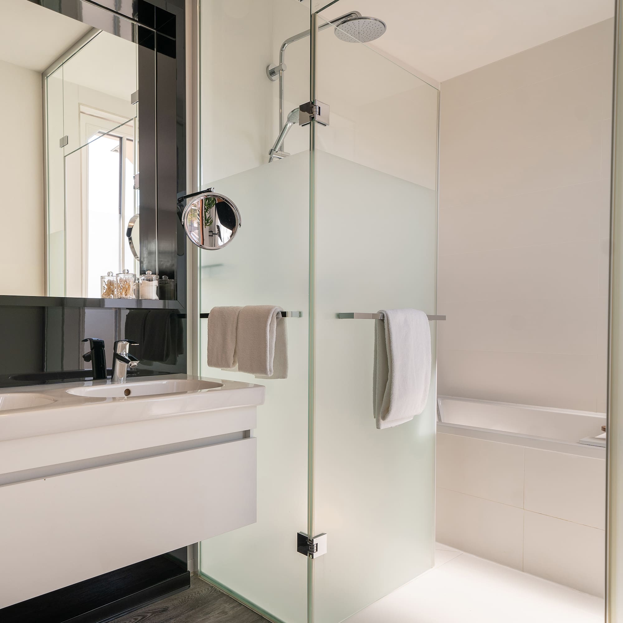 a bathroom with a glass shower and sink