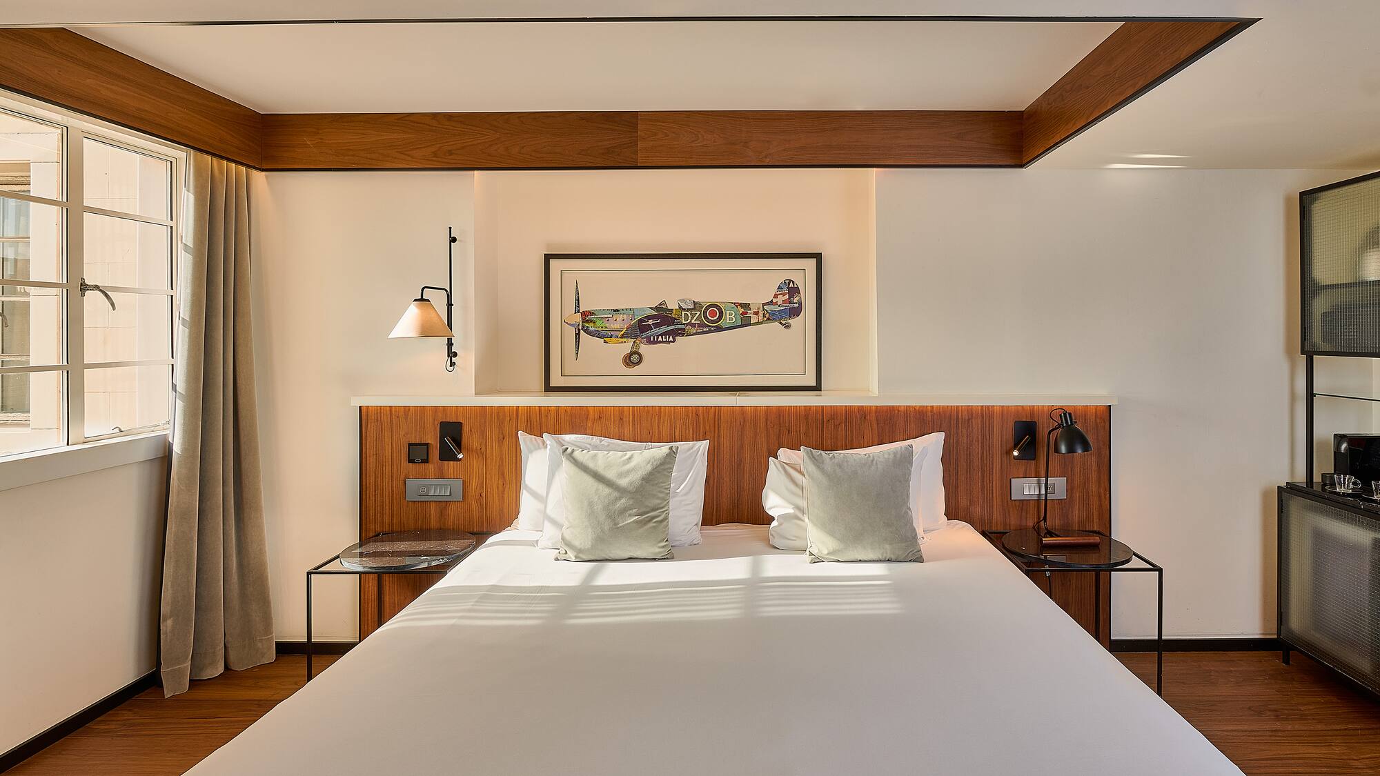 a bed with white sheets and pillows in a room