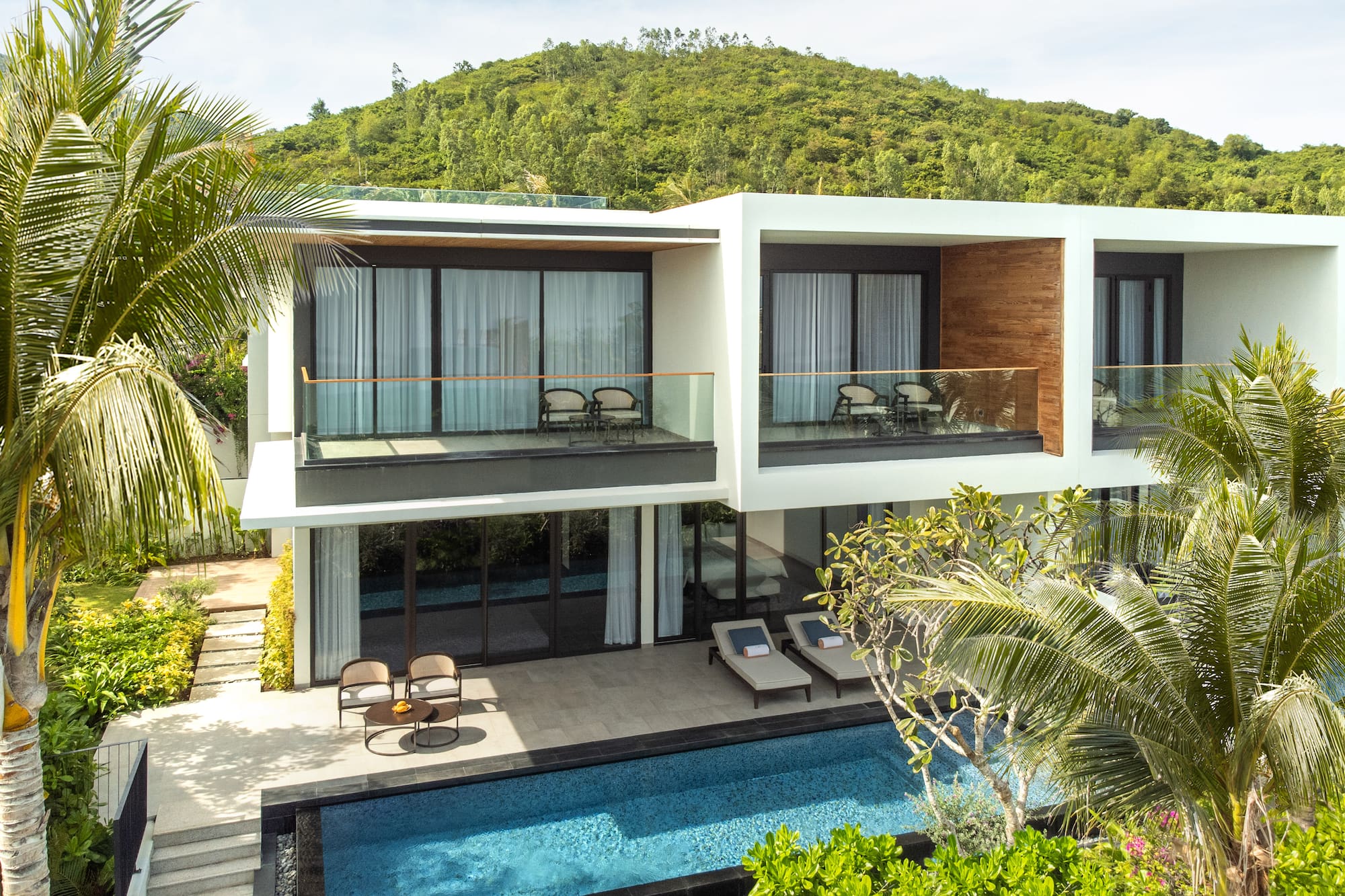 a house with a pool and trees