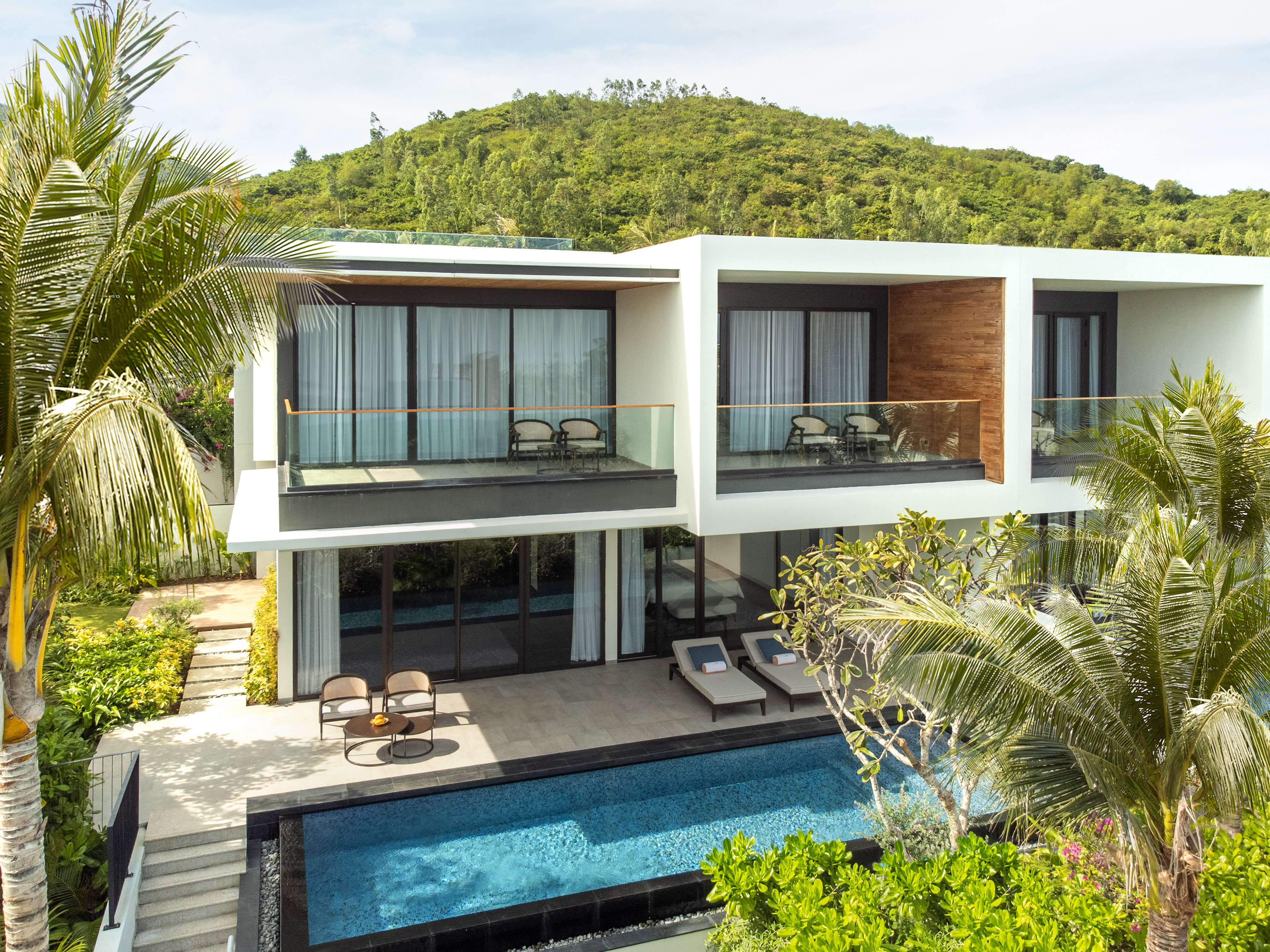 Modern luxury villa with private pool, tropical garden, and mountain view.