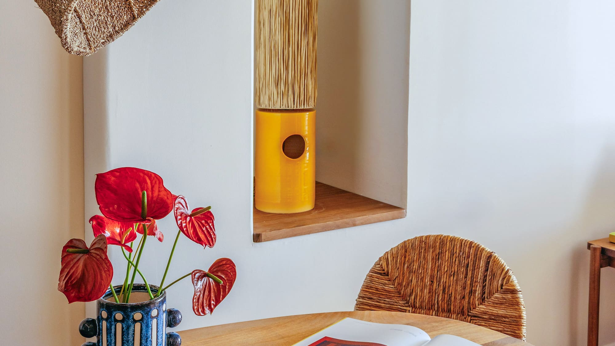 a table with a book and a vase of flowers on it