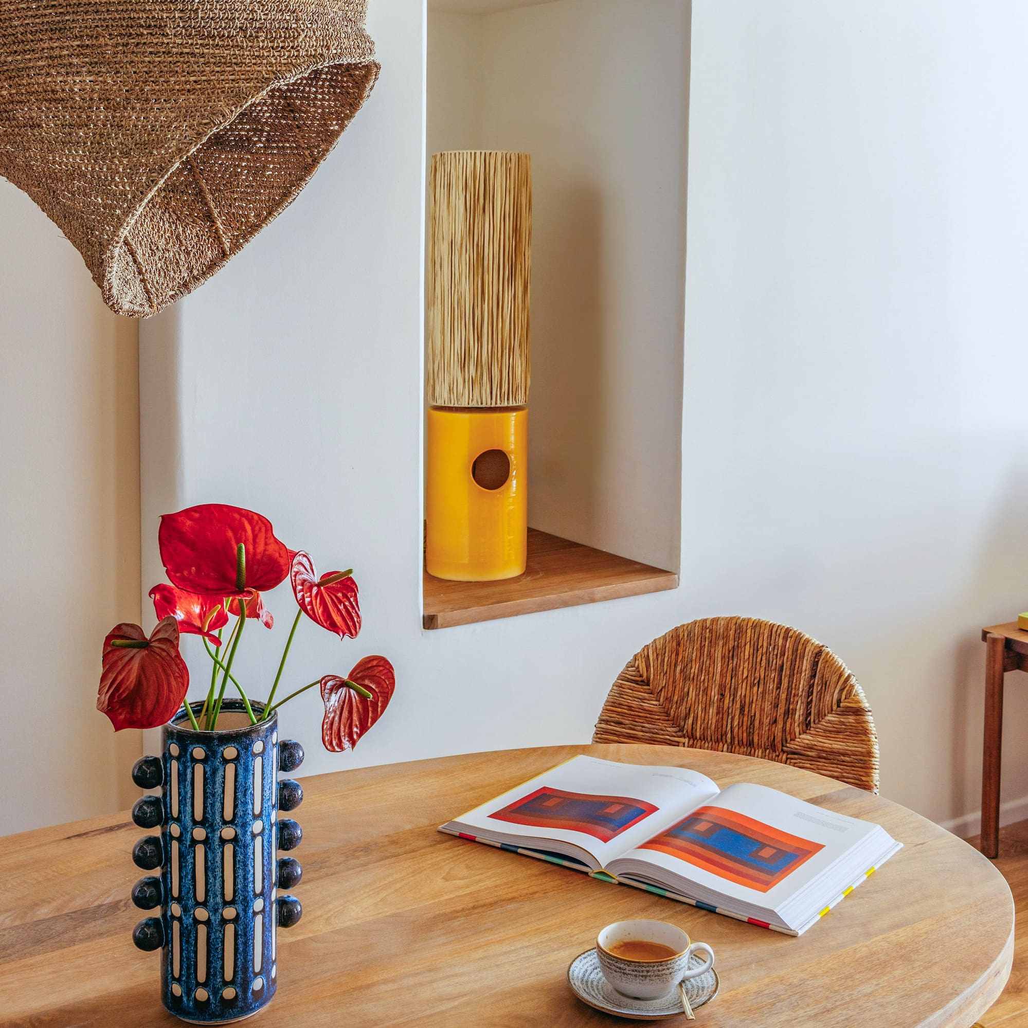 a table with a book and a vase of flowers on it