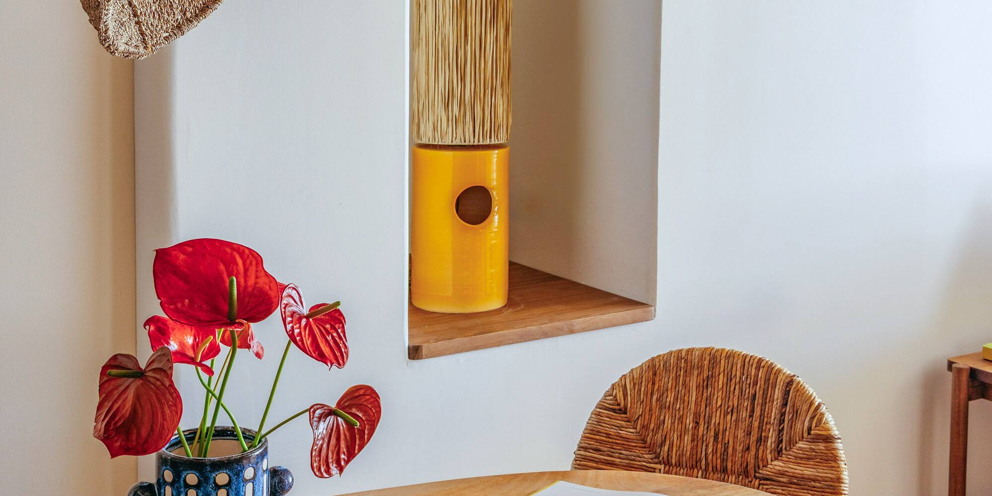 a table with a book and a vase of flowers on it