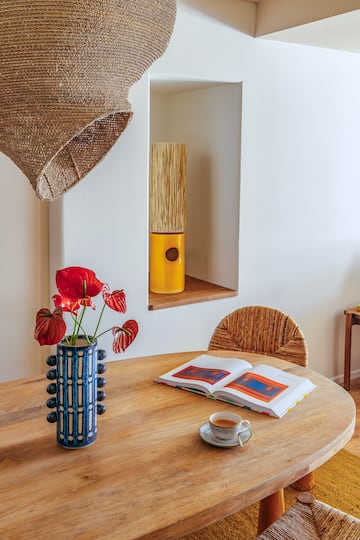 a table with a book and a vase of flowers on it