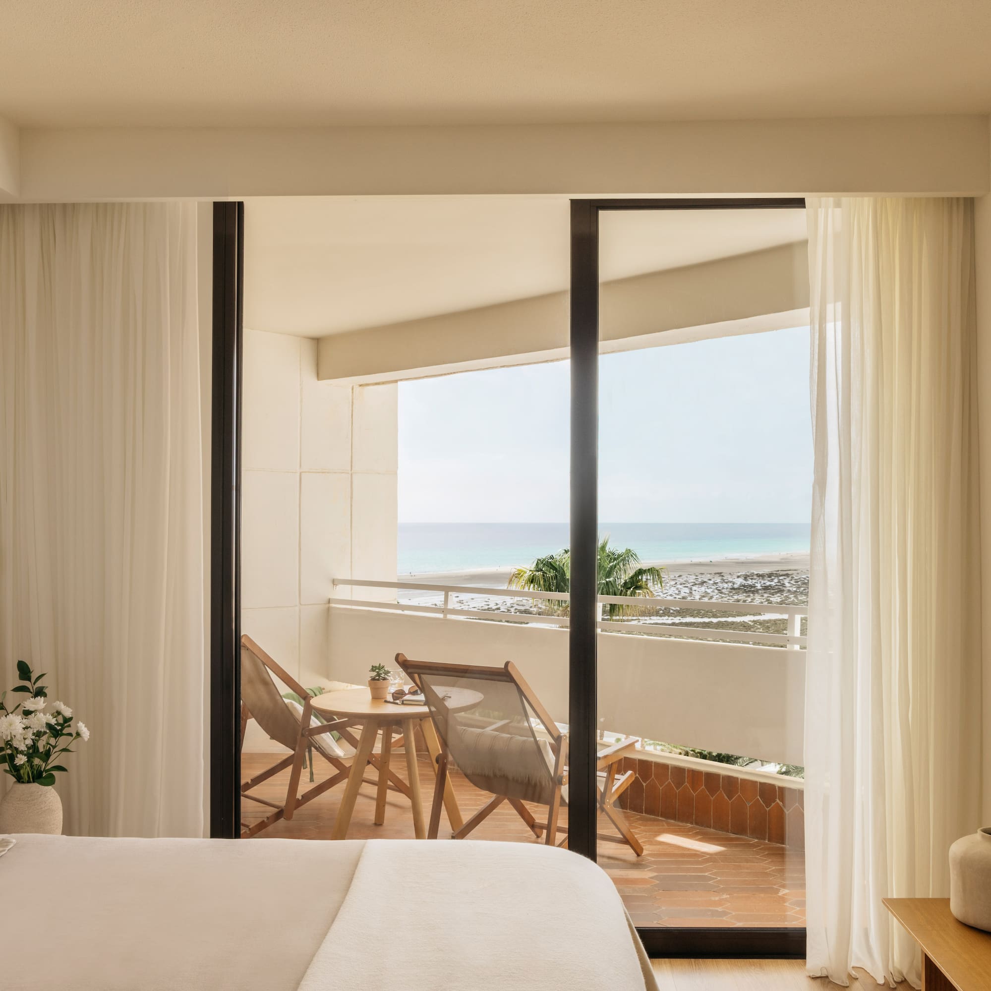 a bedroom with a view of the ocean