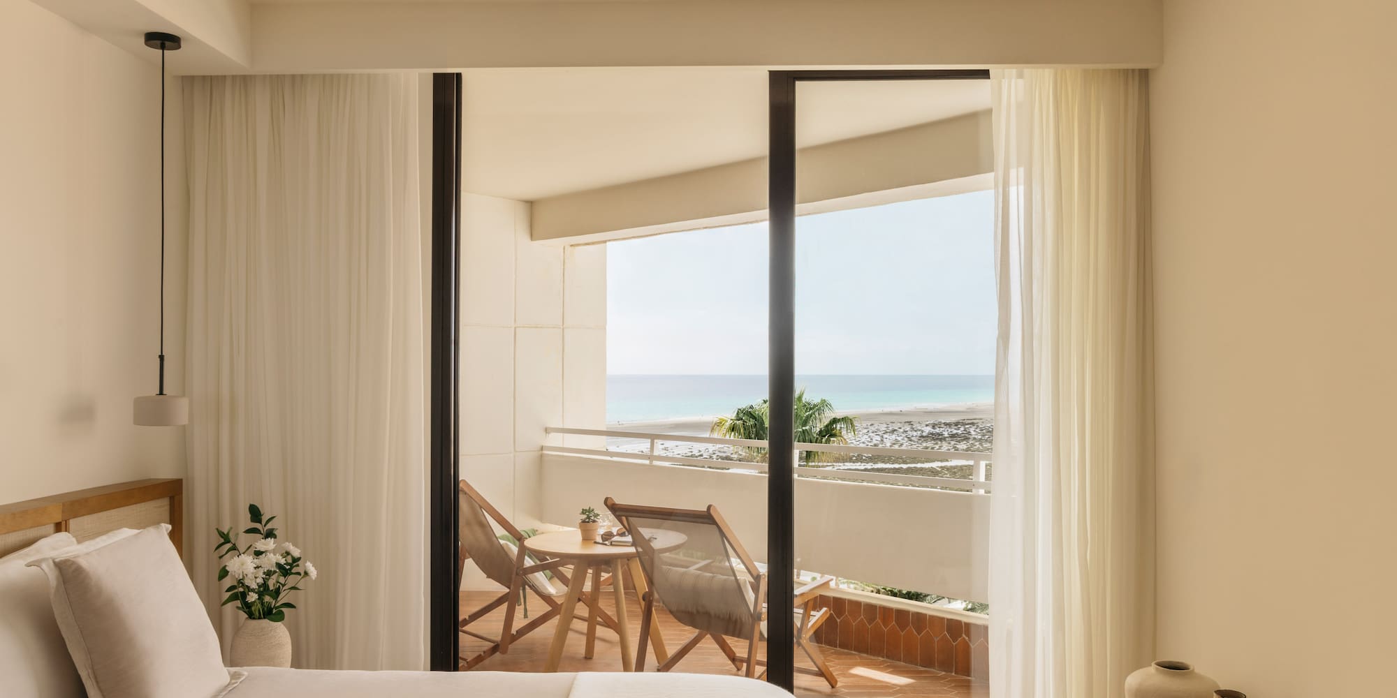 a bedroom with a view of the ocean