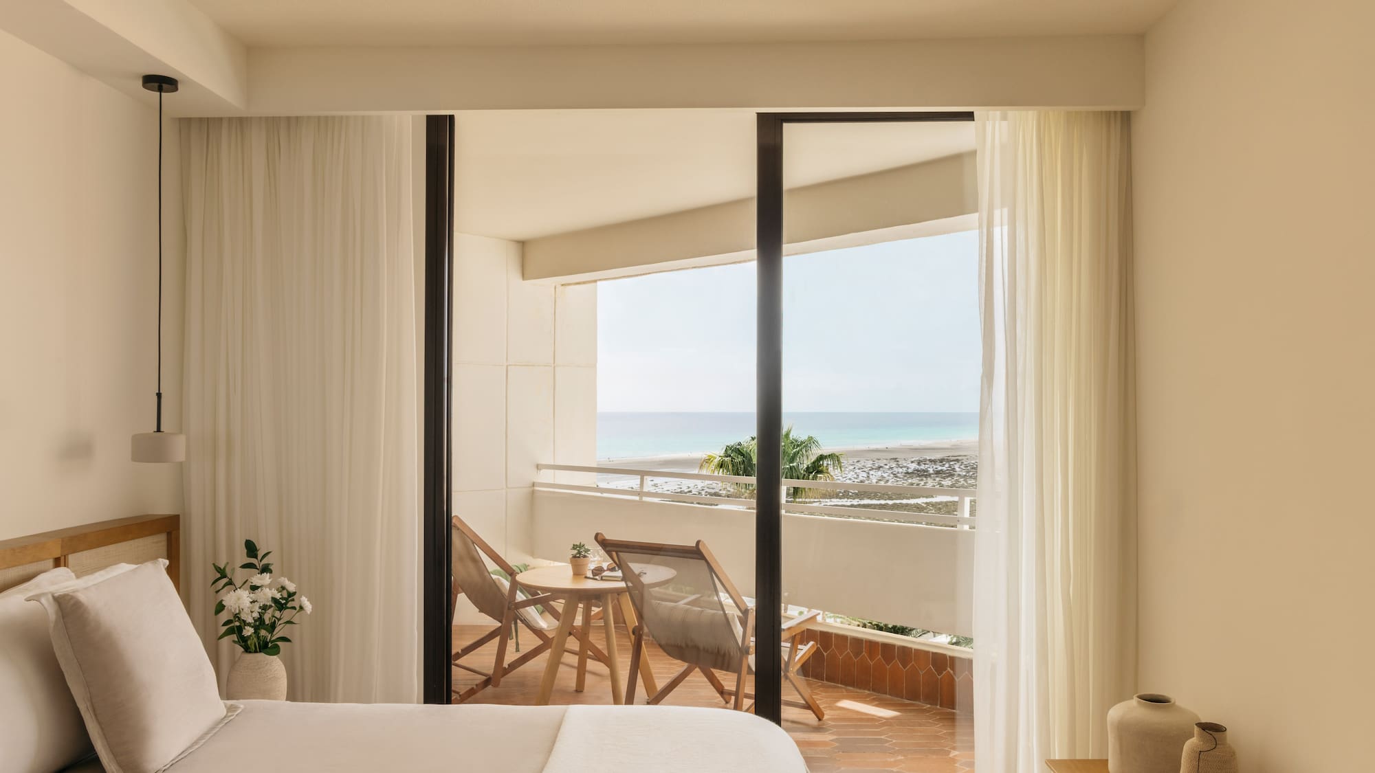 a bedroom with a view of the ocean